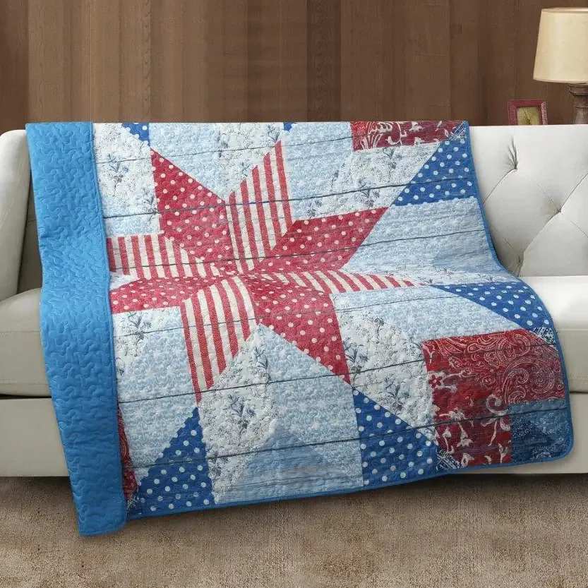 Americano Quilted Throw - 50 x 60. Quilt with floral pattern with red, blue and white color scheme. Beautiful, soft quilt for the home. Delivered on an easel for services or wrapped for home delivery.
