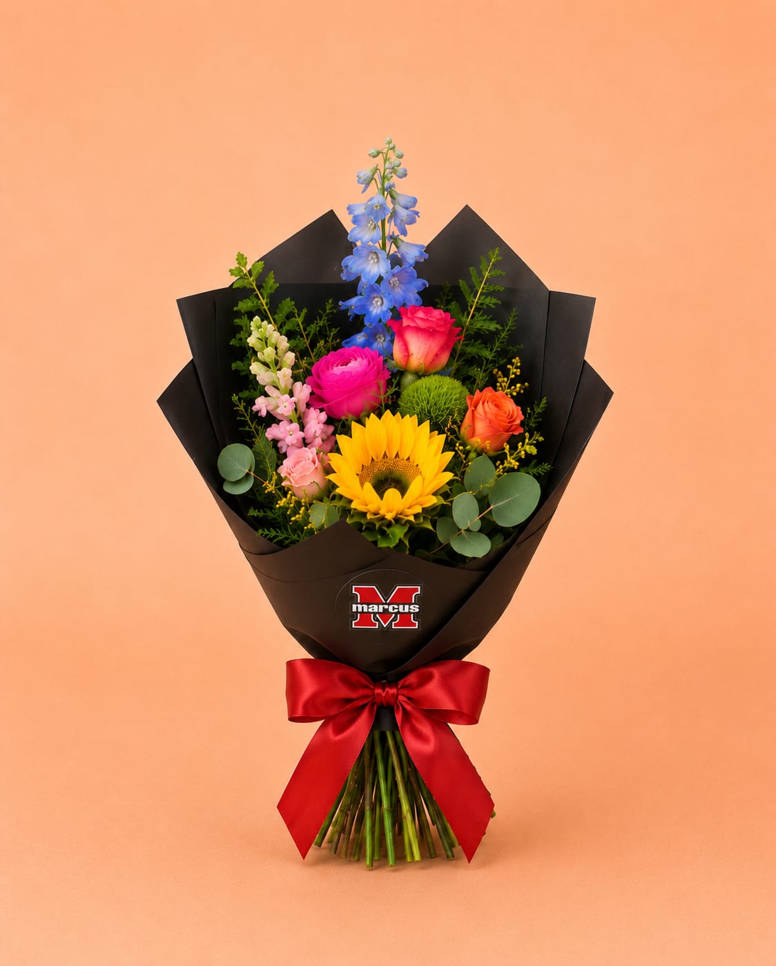 Marcus Celebration Bouquet - Celebrate your Marcus High School graduate with a custom graduation bouquet designed in school-inspired colors. The Marcus Celebration Bouquet is wrapped and finished with a Marcus High School sticker, making it perfect for graduation photos, senior celebrations, ceremony gifting, and post-graduation parties. Handcrafted by Bloom-A-Round Floral Design, your local Flower Mound florist, this bouquet is a thoughtful way to honor your favorite Marcus High School senior.