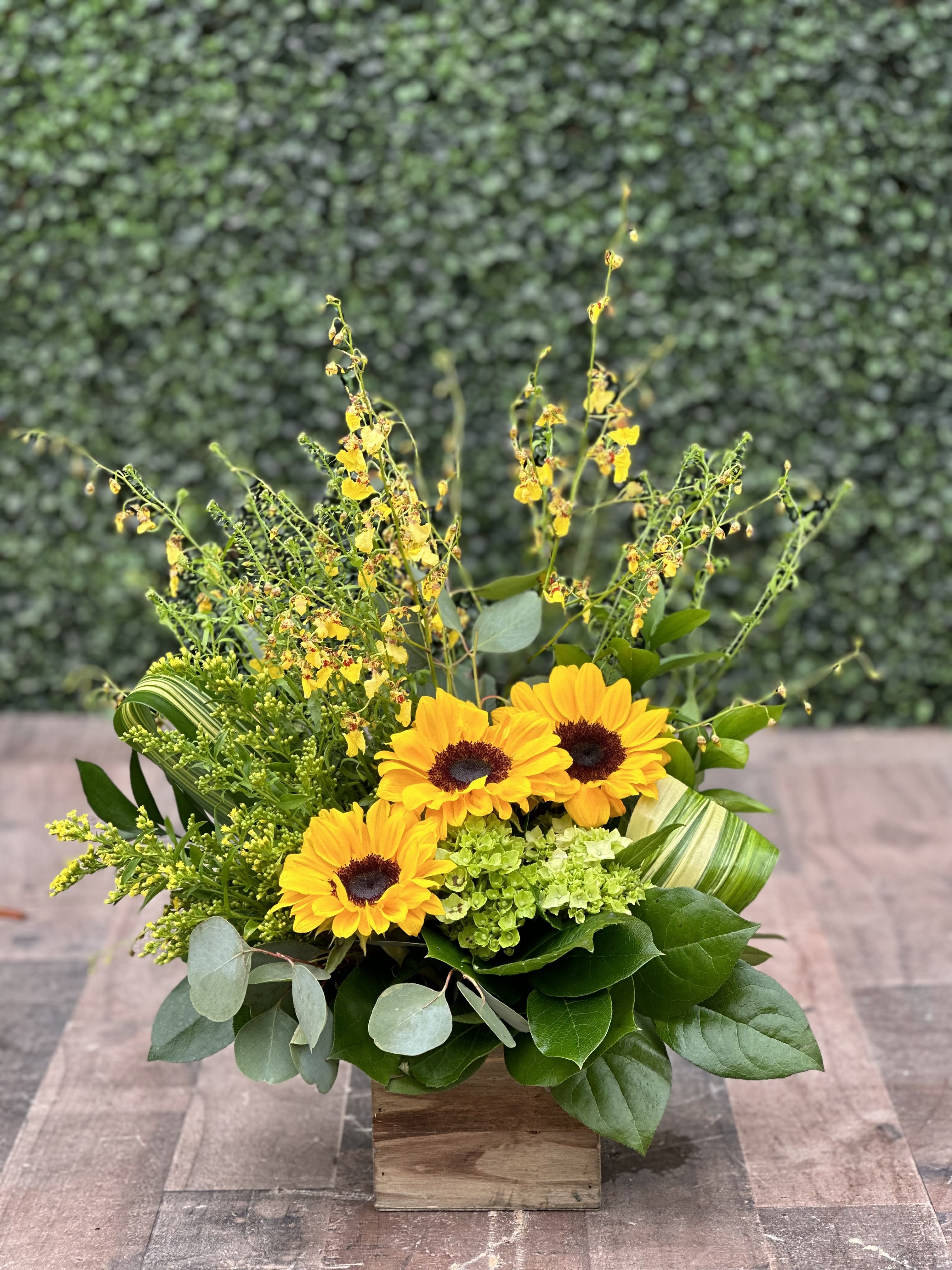 Sunflower arrangement in a wooden box with mixed greenery
