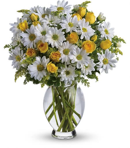 White daisies and yellow roses in a clear glass vase
