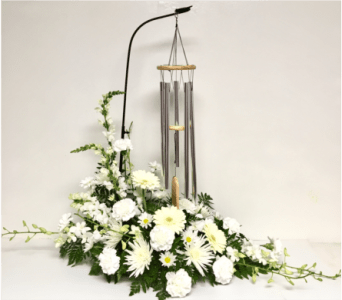 White floral arrangement with hanging wind chimes