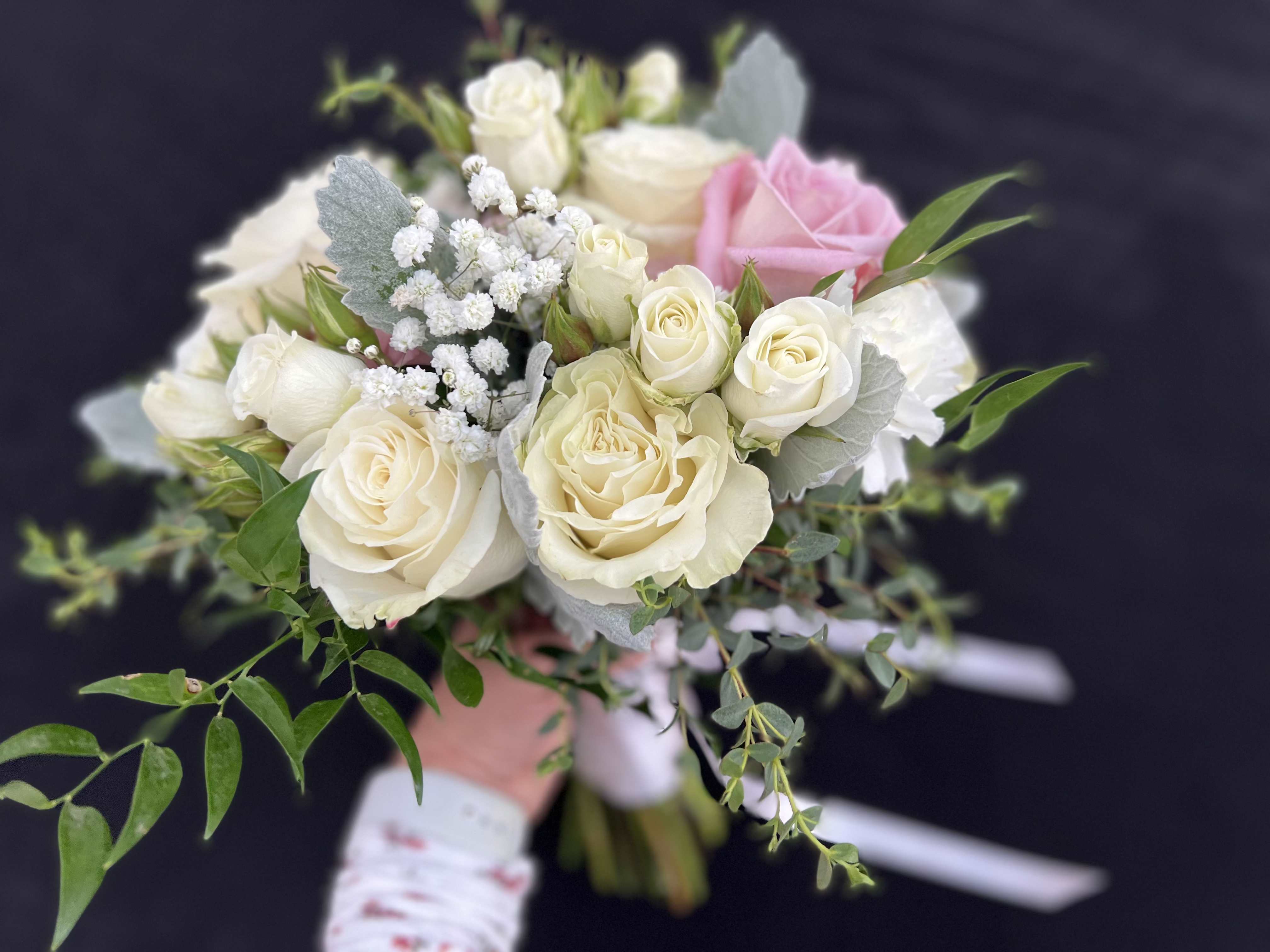 Bouquet of cream and pink roses with white filler flowers