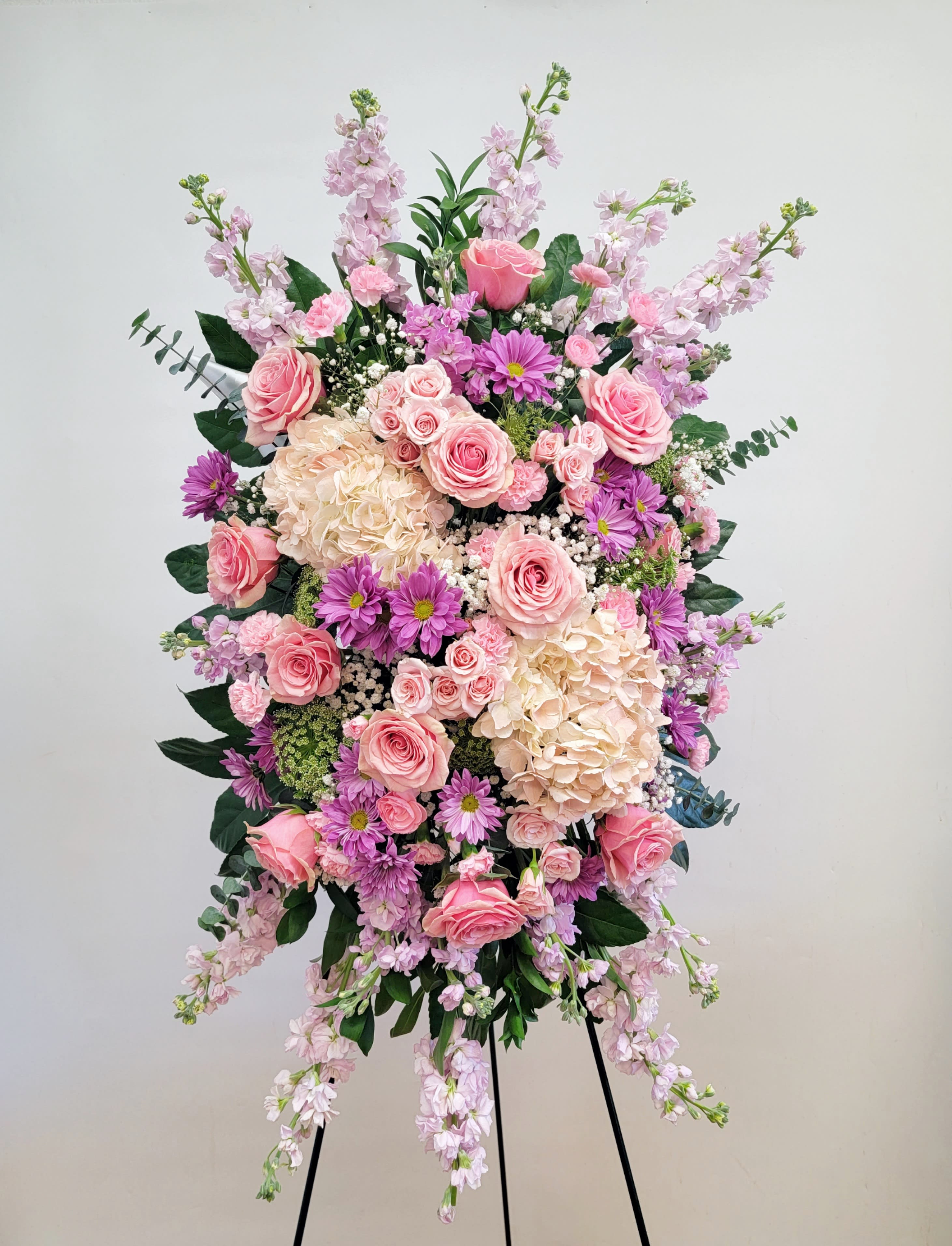 Tall pink and lavender floral spray on a stand