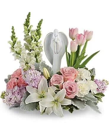 Pink roses and white lilies arranged around a silver angel keepsake