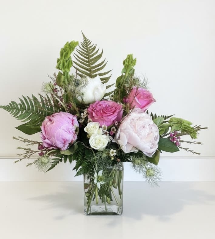 Perfectly Peony - We have peonies in stock, once they are gone, they are gone! Limited time only!   Soft pink and creamy white  mingle with abundant greenery in a romantic bouquet perfect for a birthday bouquet, anniversary roses, or a spring wedding centerpiece. The bright pink blooms give an immediate lift while white roses add a gentle, classic note-the kind of arrangement that makes the person you're thinking of feel cherished and celebrated.  