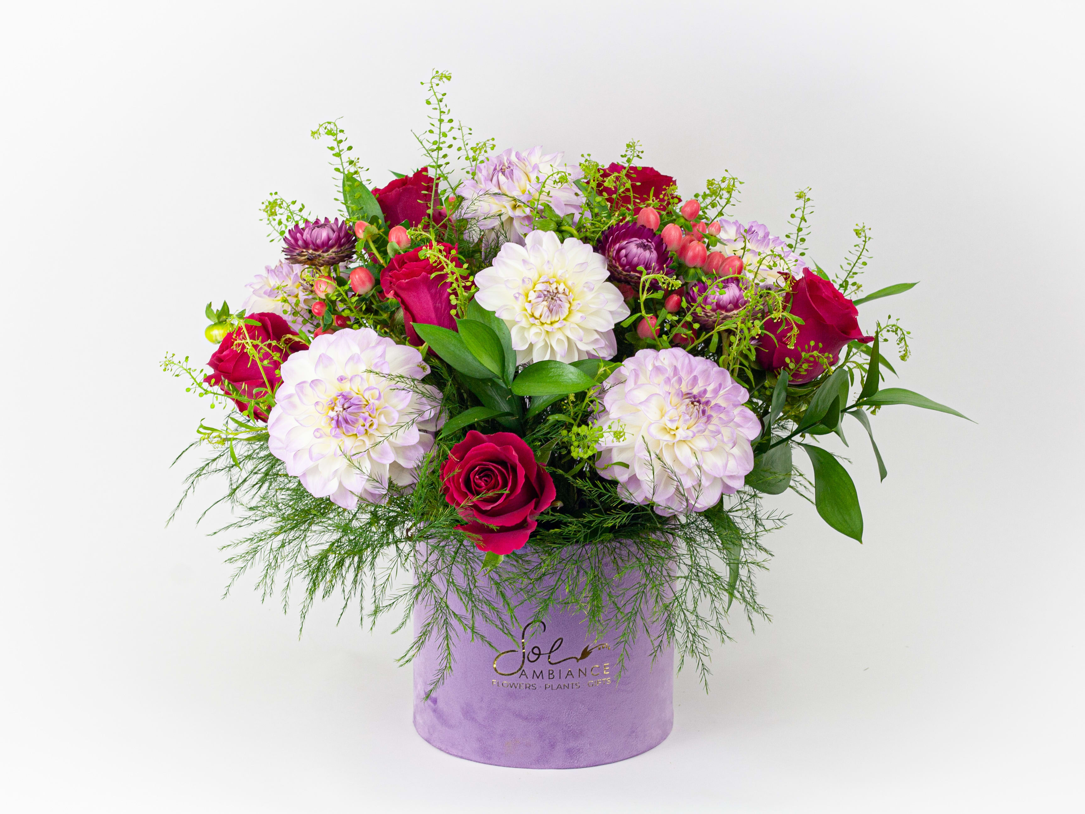 Mixed bouquet of pink and white flowers in a lavender hat box