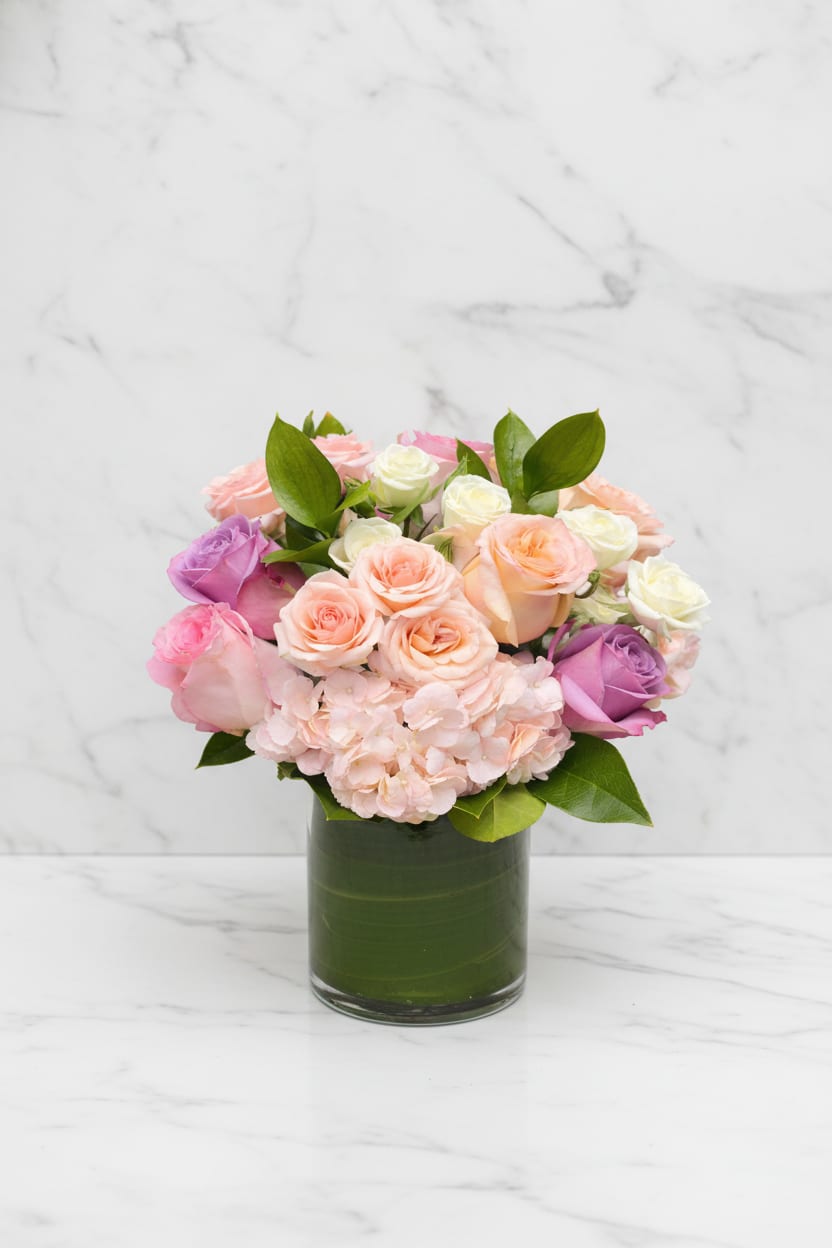 Blush and Bloom - Blush &amp; Bloom is a romantic Valentine’s Day arrangement featuring a lush mix of blush, peach, pink, and ivory roses paired with soft hydrangea and seasonal greenery. Designed in our signature modern style, this bouquet is perfect for celebrating love, anniversaries, or meaningful moments.  Elegant, timeless, and effortlessly romantic, Blush &amp; Bloom makes a beautiful statement for Valentine’s Day or any occasion that calls for something special.