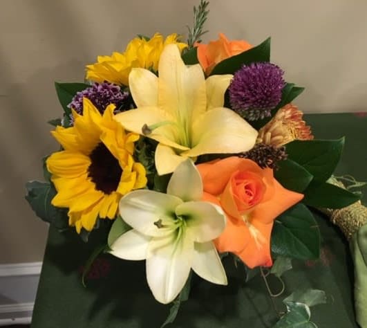 Bouquet with sunflowers, lilies, and orange roses