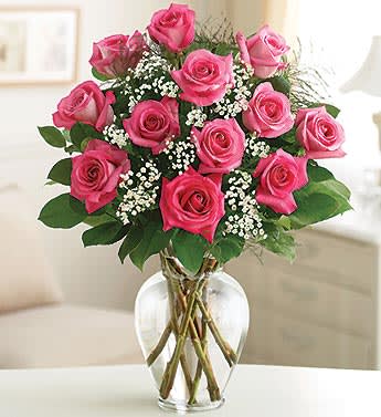 Pink roses arranged in a clear glass vase