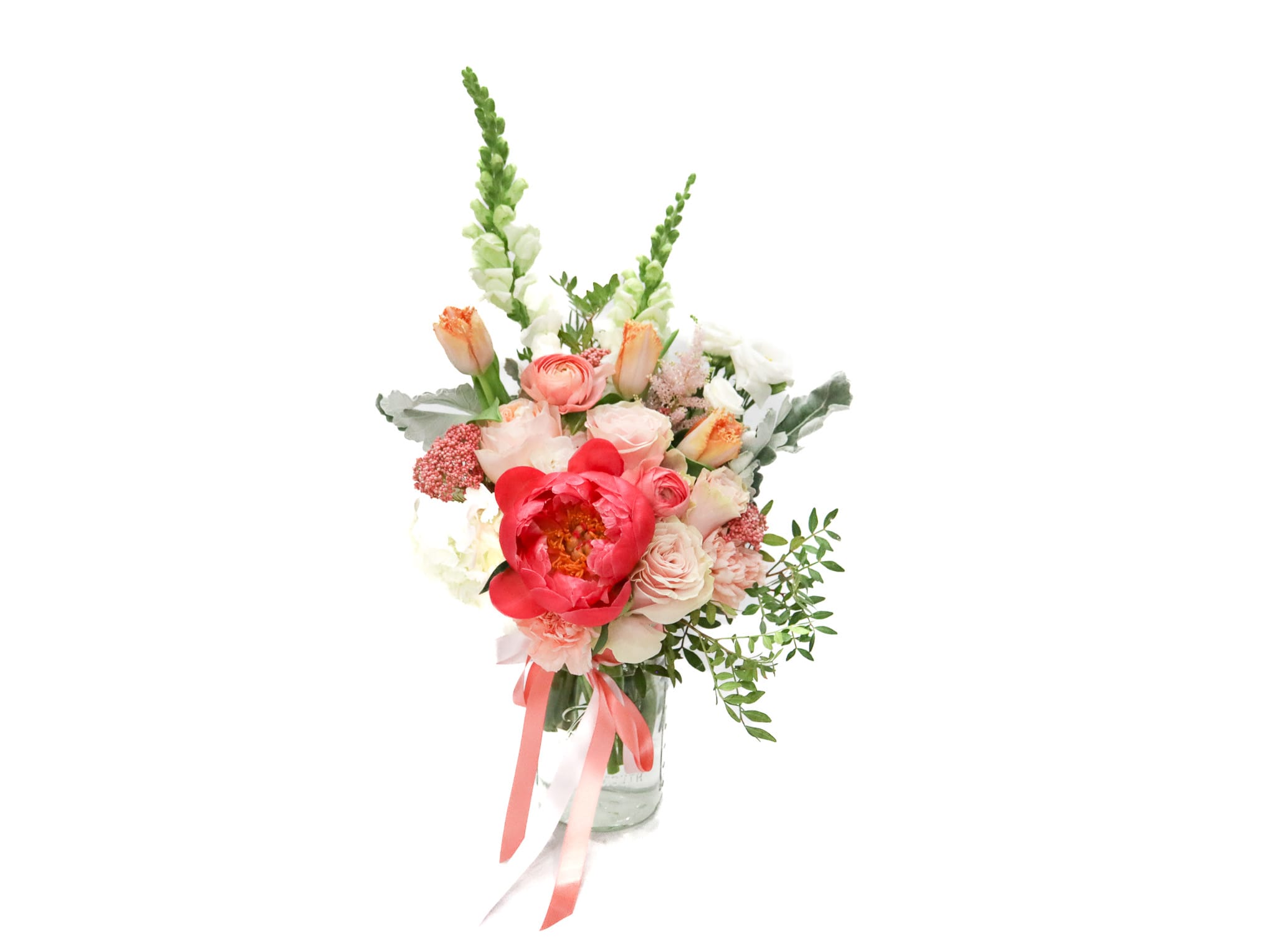 Pink and white bouquet in a glass vase with tall green spikes