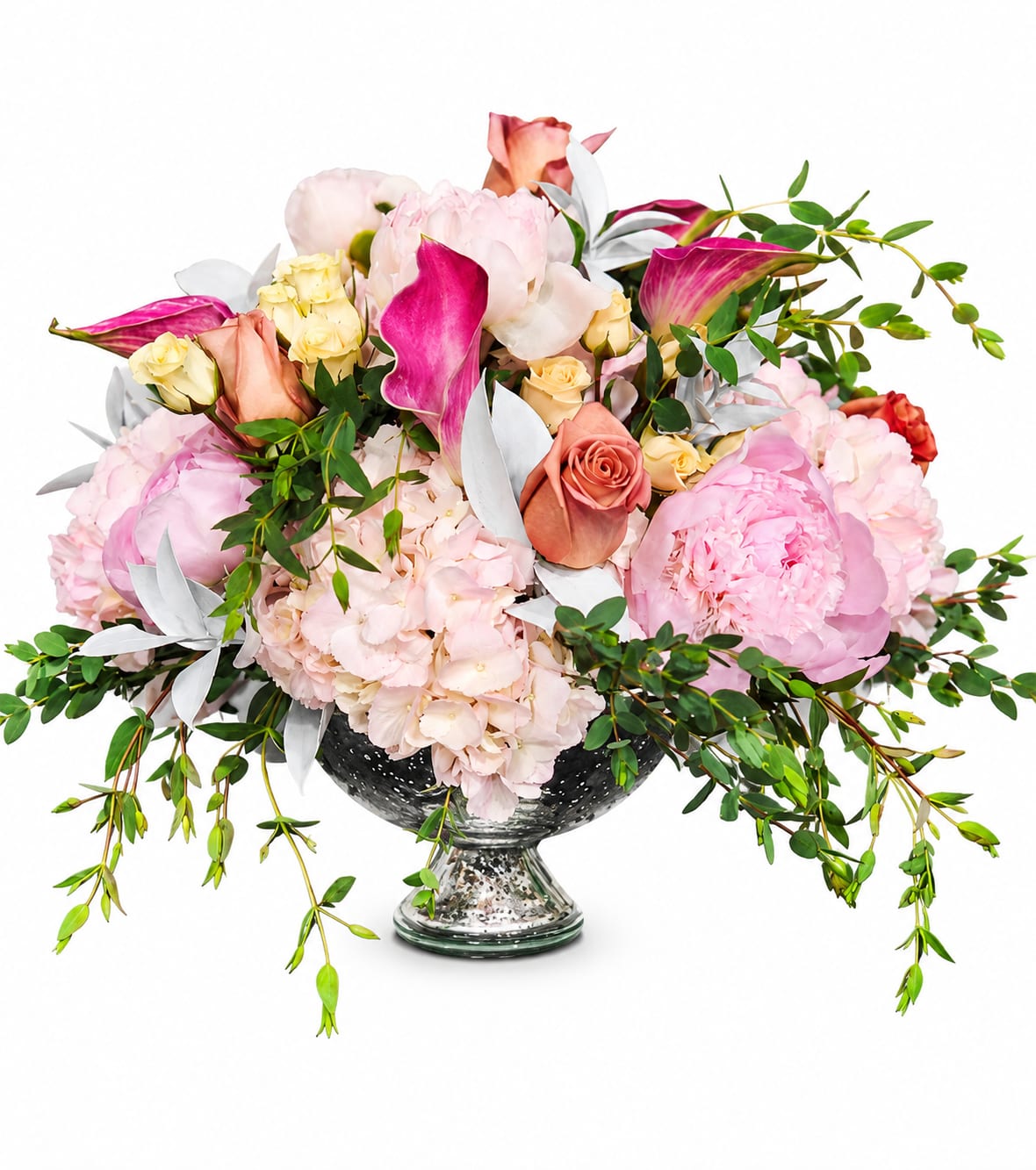 Enchanted Bloom - Blush Elegance is a luxurious floral arrangement designed with soft pink peonies, blush roses, delicate hydrangeas, and vibrant calla lilies accented with flowing greenery and silver eucalyptus. Arranged in an elegant pedestal vase, this romantic centerpiece brings timeless beauty and sophistication to any occasion. Perfect for weddings, anniversaries, birthdays, sympathy gestures, or upscale celebrations, Blush Elegance creates a stunning statement with its lush textures, graceful movement, and soft pastel palette.