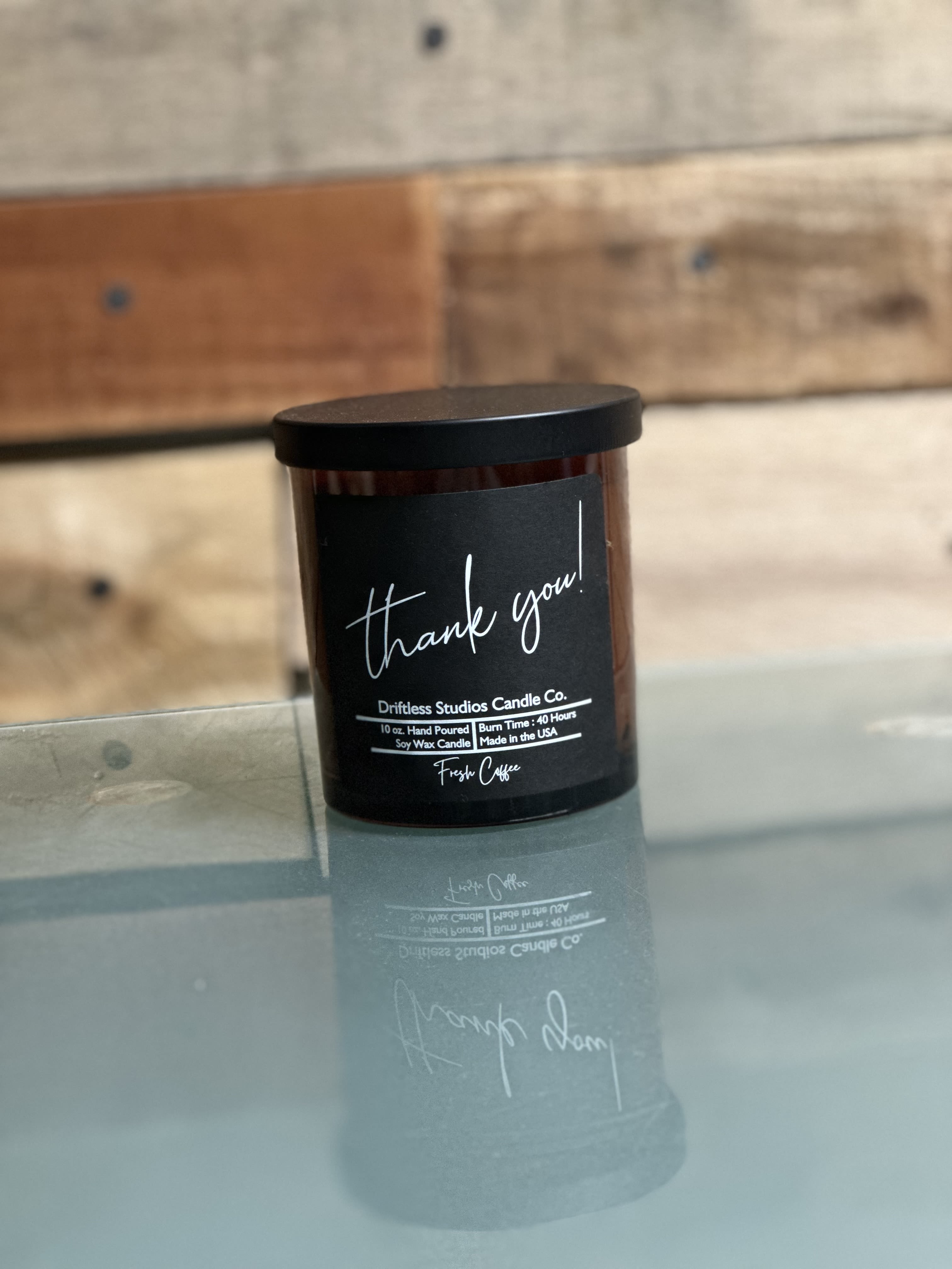 Black jar candle with a "thank you!" label