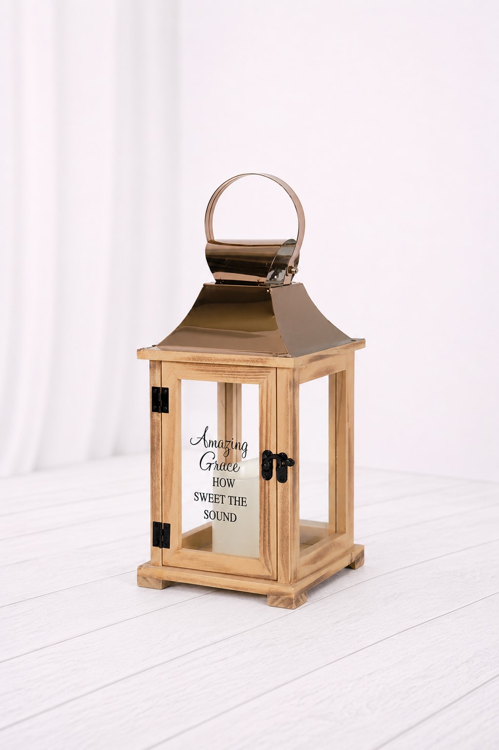 Wooden lantern with a metal top and glass panels