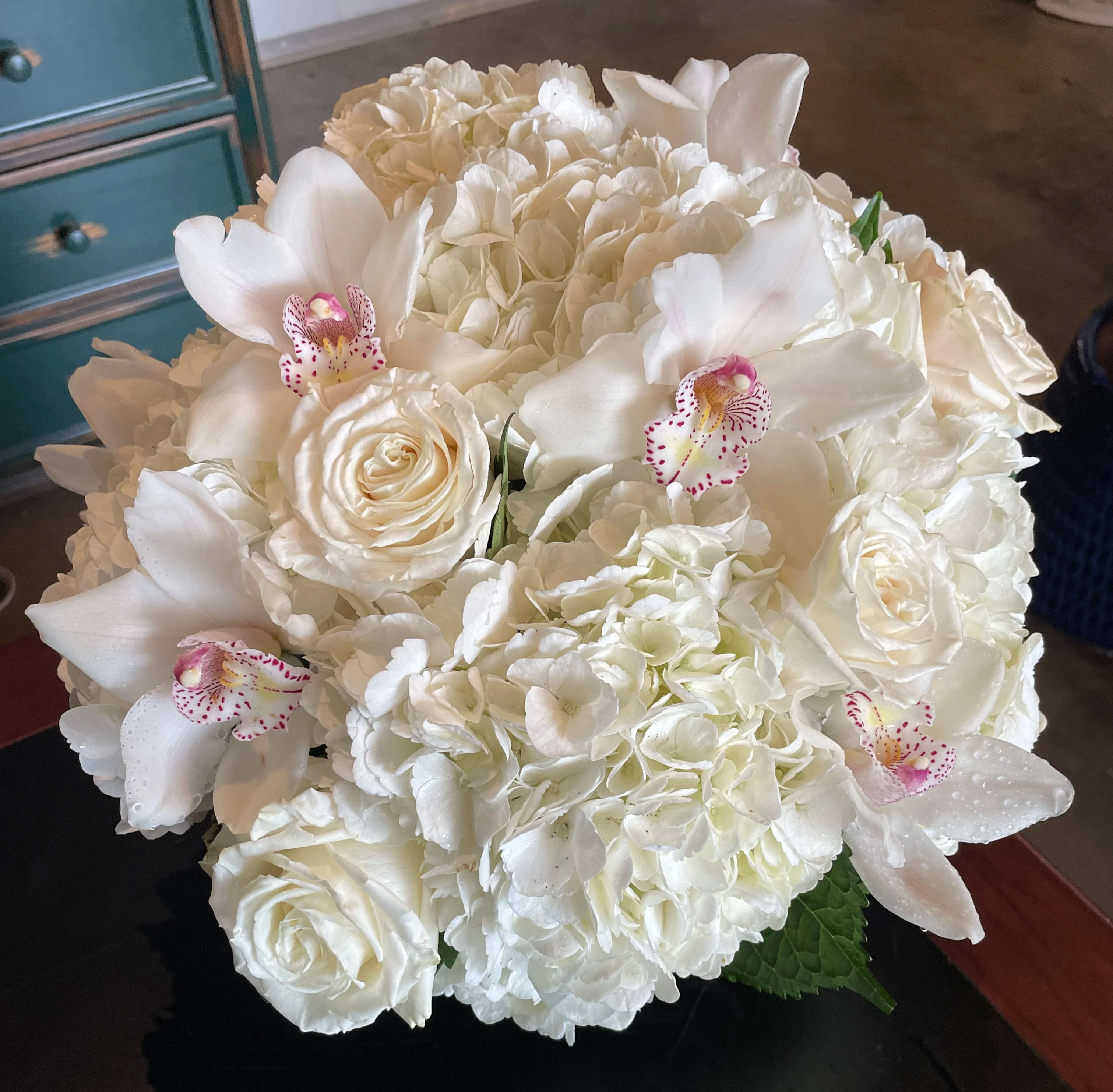 White bouquet with roses, hydrangeas, and orchids