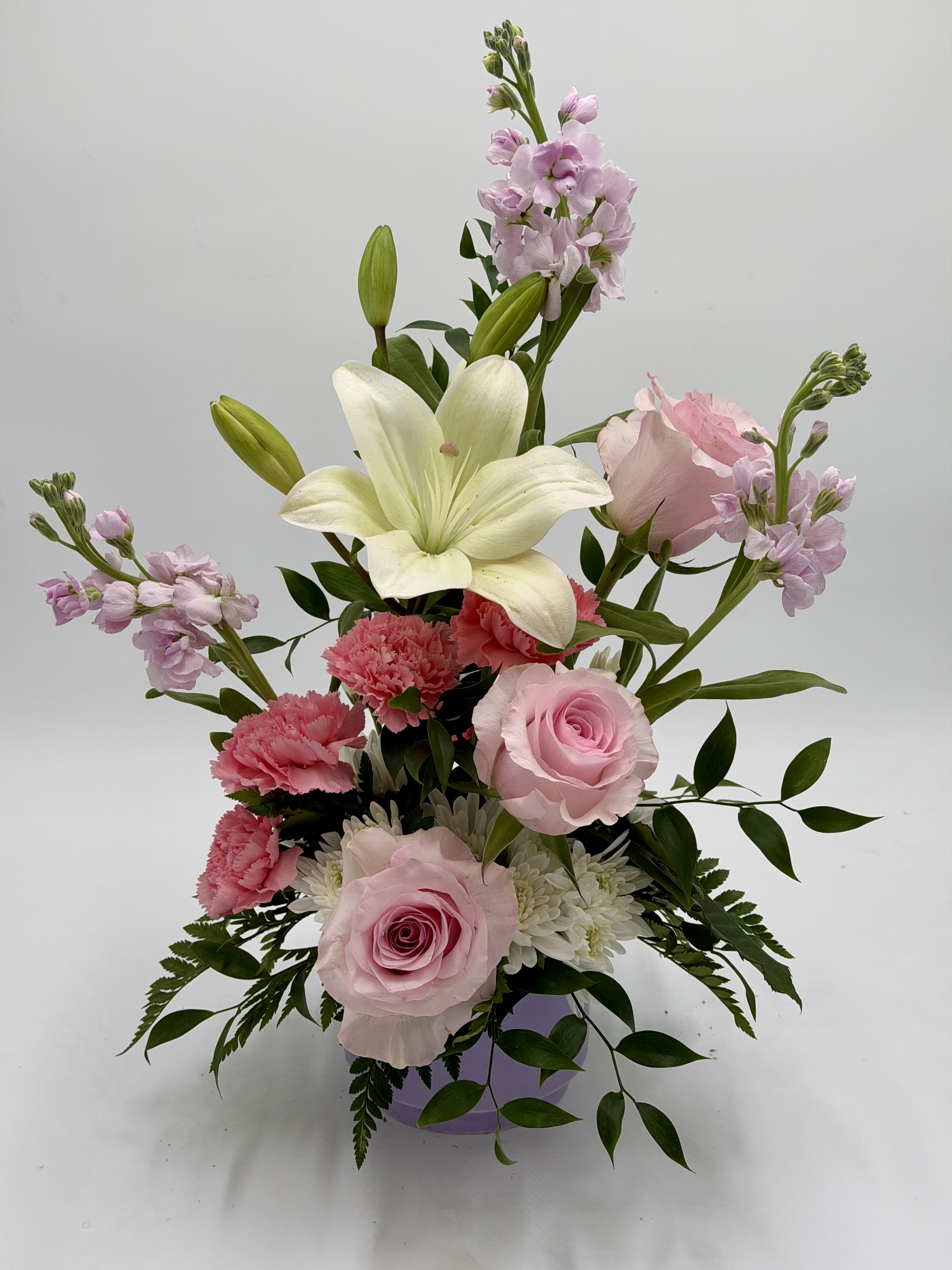 Rosy Daydream - Rosy Daydream is a soft and romantic arrangement designed with delicate shades of blush pink and creamy white blooms. Featuring elegant roses, fragrant lilies, cheerful carnations, and seasonal accents, this arrangement brings a graceful touch to any occasion. Perfect for birthdays, anniversaries, get well wishes, or simply brightening someone’s day with a little beauty and love.