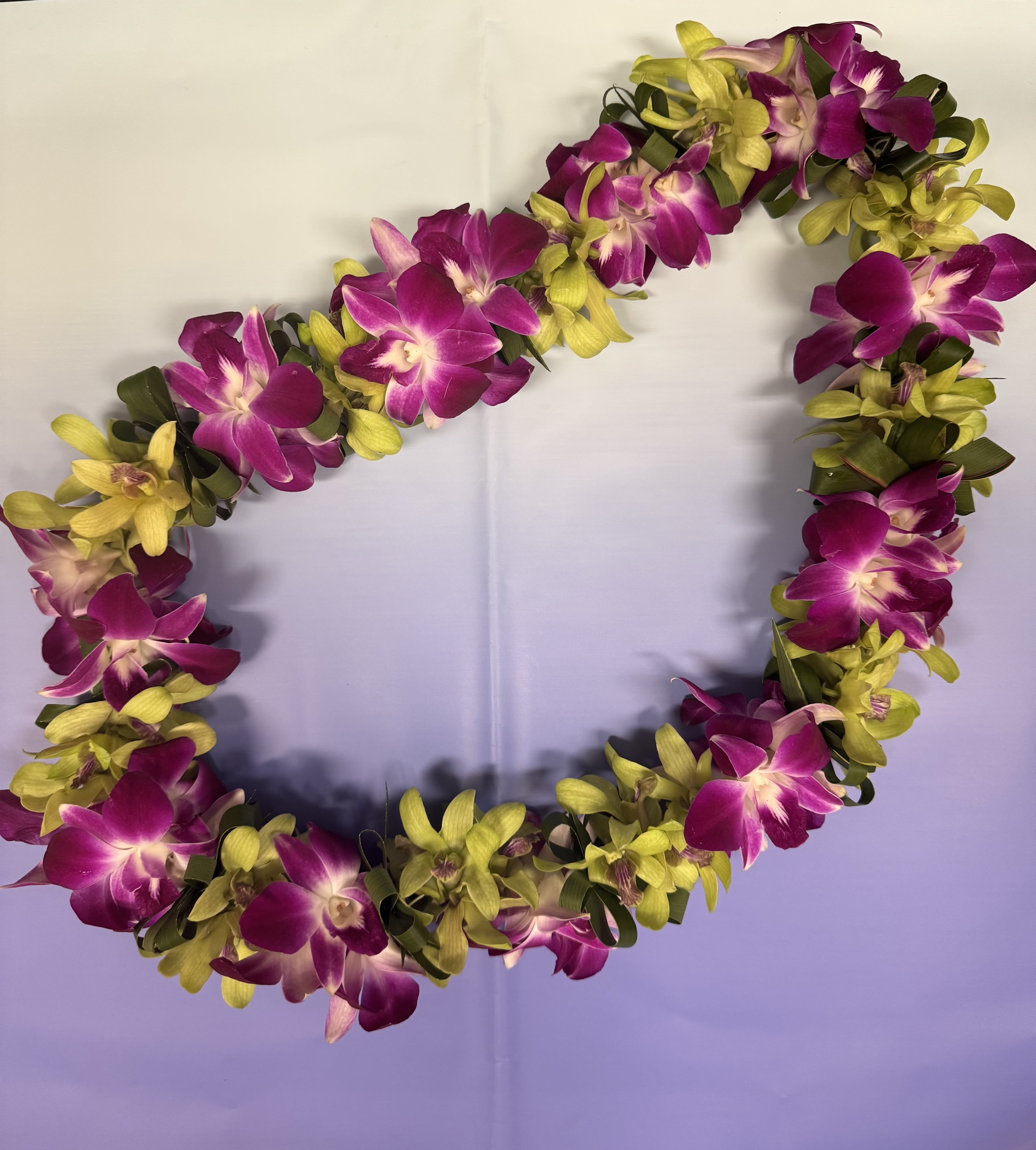 Lei 32 - This beautiful made with green and purple dendrobium orchid and ti leaf 