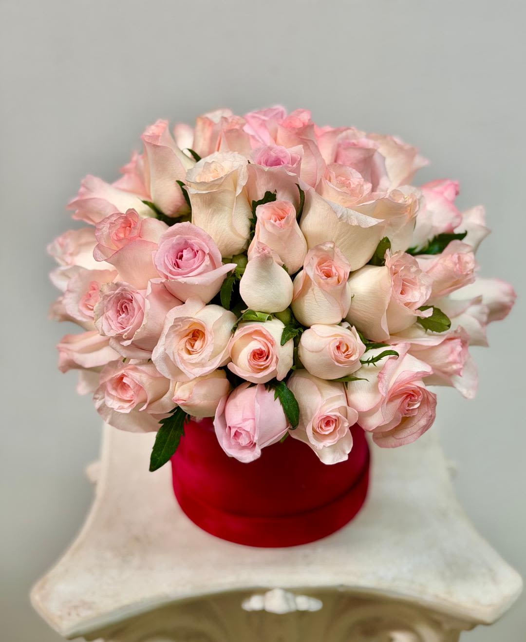 Parisian -Style Hat Box - Product Information  Arrangement includes roses in a pink velvet box  Arrangement may look different  Substitution Policy In some instances, our photo may represent an overall theme or look and include a one-of-a-kind vase which cannot be exactly replicated.  Although the actual bouquet may not precisely match the photo, its temperament will. Occasionally, substitutions of flowers and/or containers happen due to weather, seasonality and market conditions which may affect availability. If this is the case with the gift you’ve selected, we will ensure that the style, theme and color scheme of your arrangement is preserved and will only substitute items of equal value or higher value.  If any design elements are of major importance to your order, please include them in the florist instructions at checkout or contact us to ensure availability.