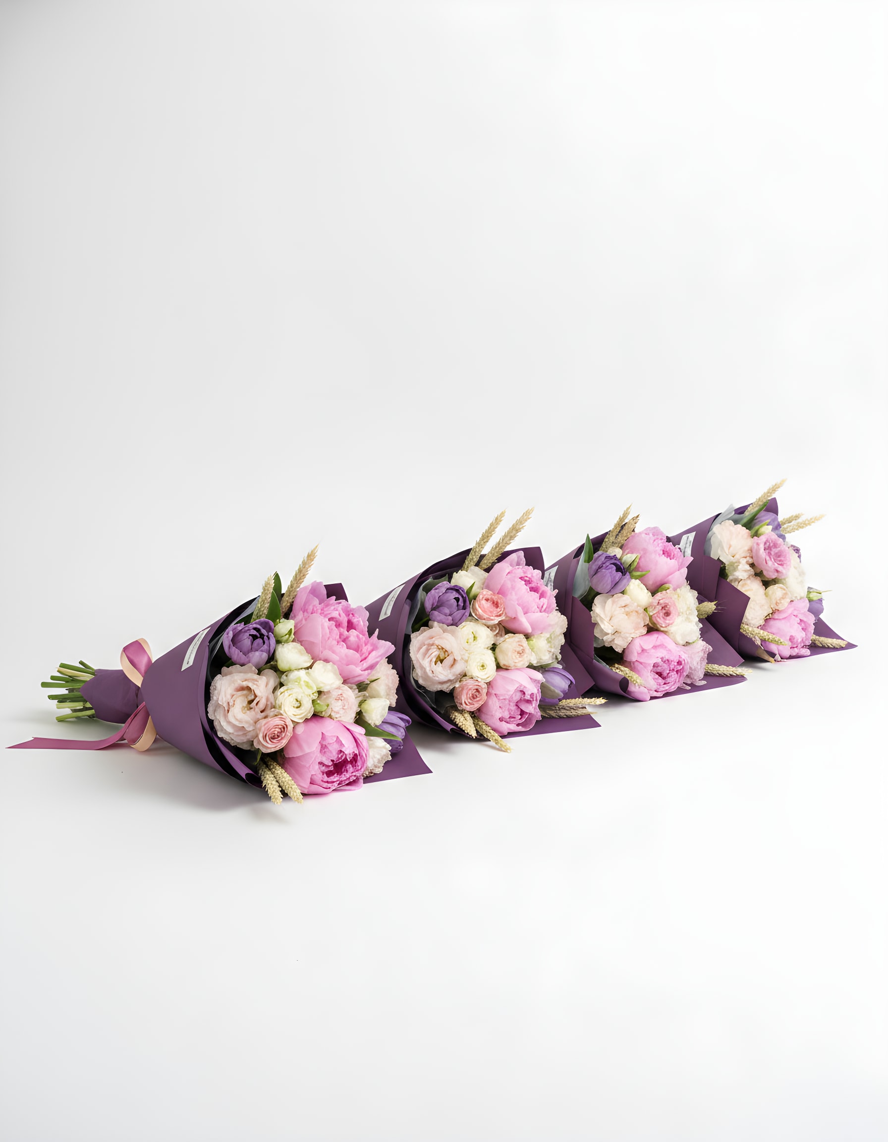 Bloom Bouquet Bundle (4 bouquets) - A set of four hand-tied bouquets, each featuring 12 beautiful stems, making them perfect for favors and thoughtful gifts. Elegantly wrapped in a vibrant floral paper and finished with an elegant ribbon, these bouquets are designed to delight and impress. Sold as a complete set. 
