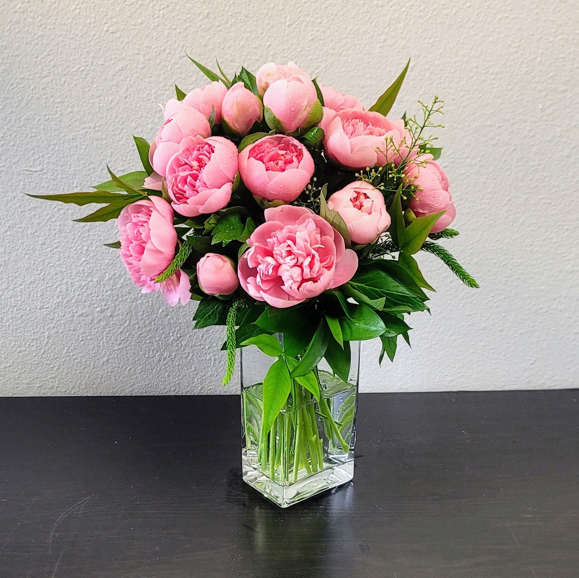 Pink peony bouquet in a clear glass vase