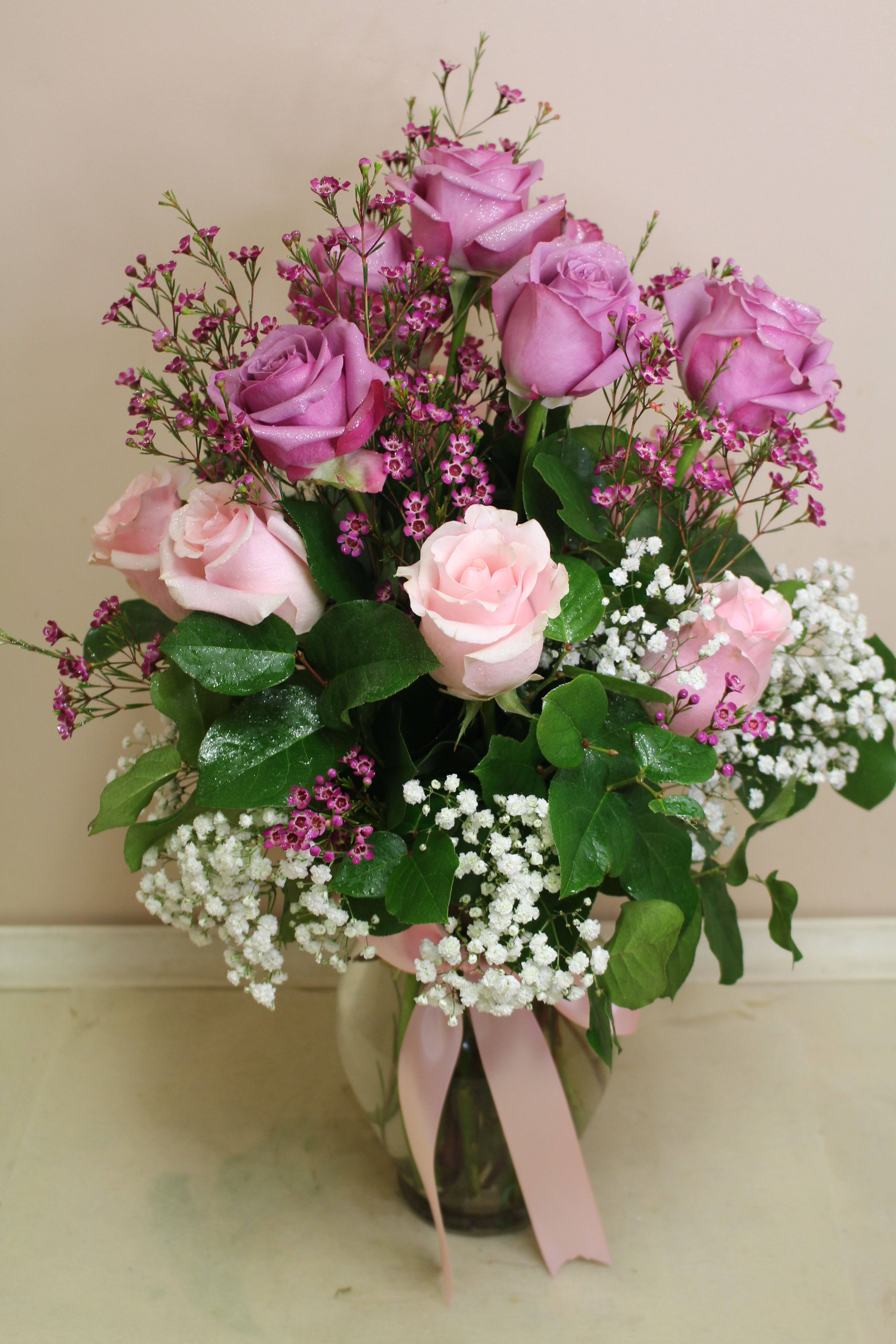sweetie girl  - 6 purple, 6 pink roses arranged in a vase with wax and babies breath
