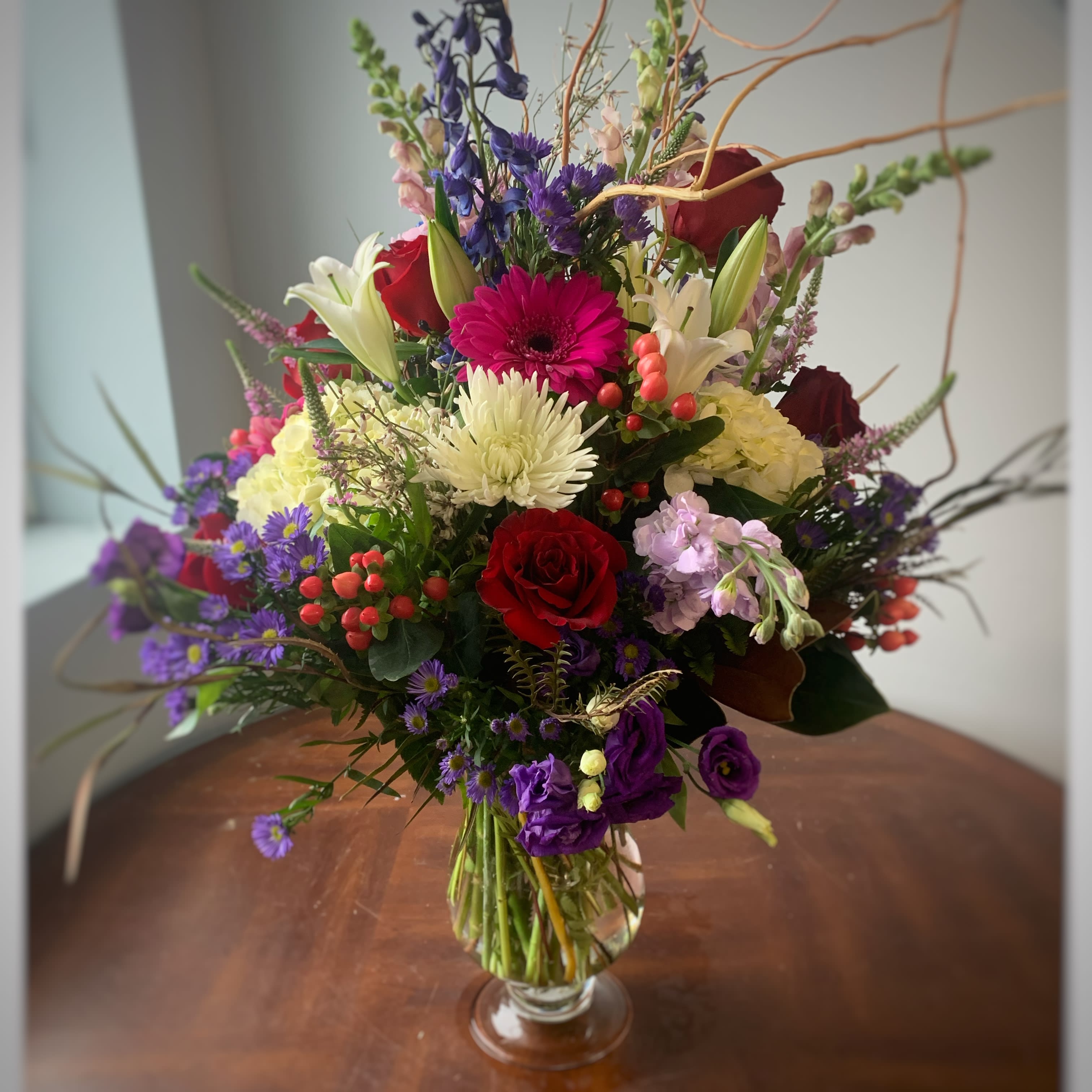 Mother's love - Large fresh floral in a lovely glass container filled with hydrangeas, roses,lilies and more quality, seasonal flowers