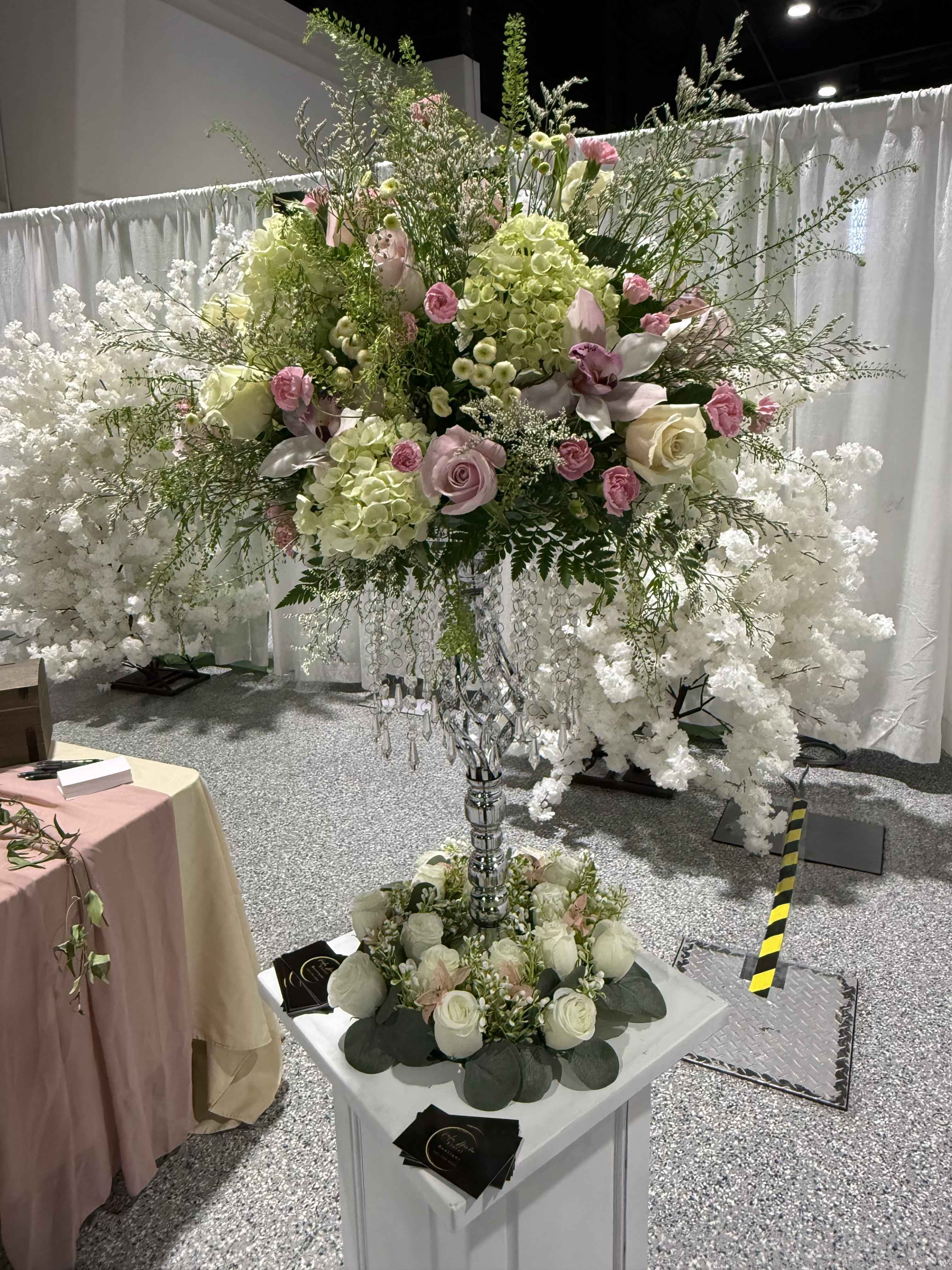 Luxury Elevated Floral Centerpiece - A grand statement arrangement featuring premium blooms designed on an elevated stand for an elegant, sophisticated, and unforgettable reception design.