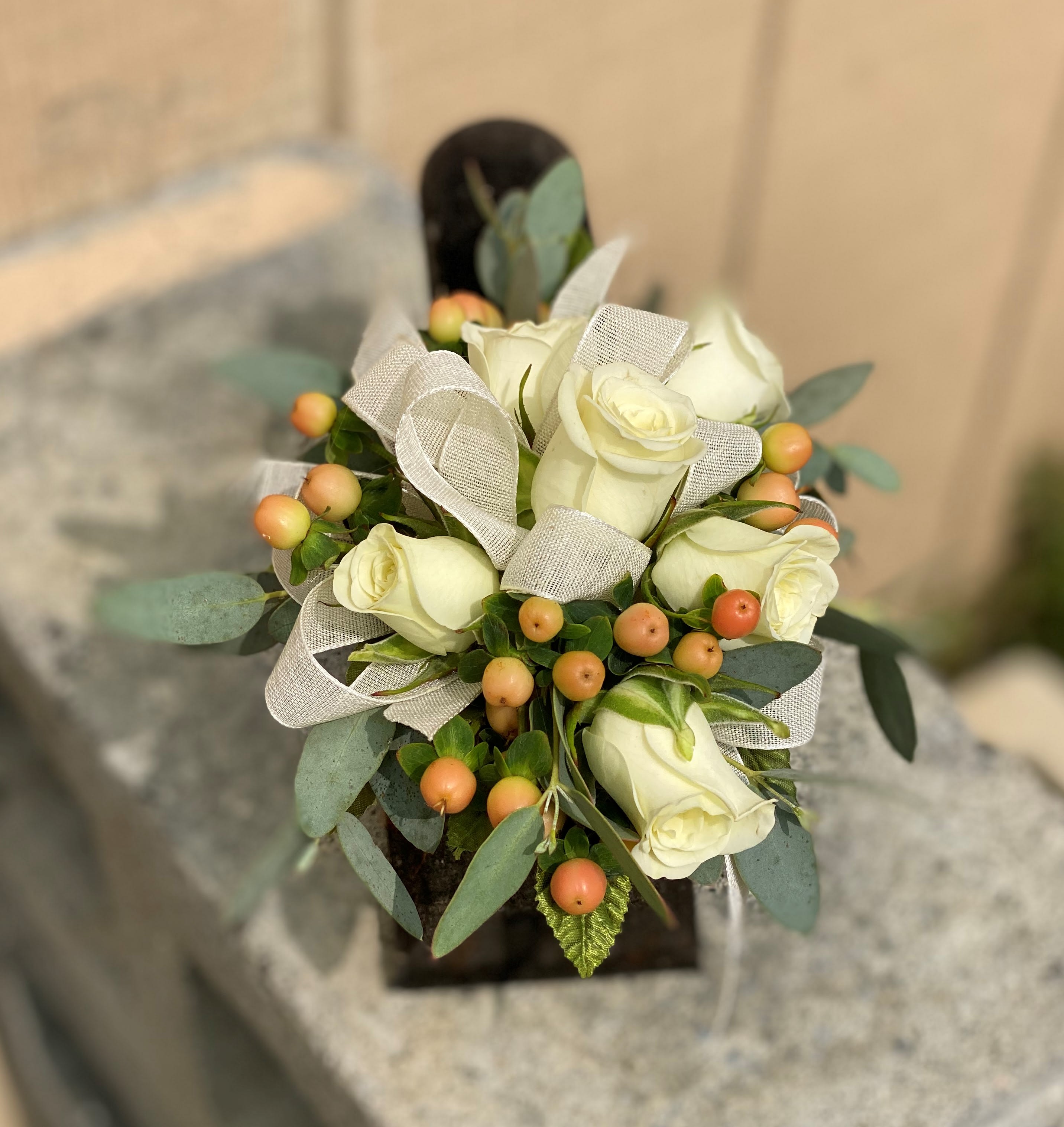 The Natural Beauty - This wrist corsage is made up of white spray roses, peach hypericum berries, eucalyptus and finished off with a neutral grey ribbon. 