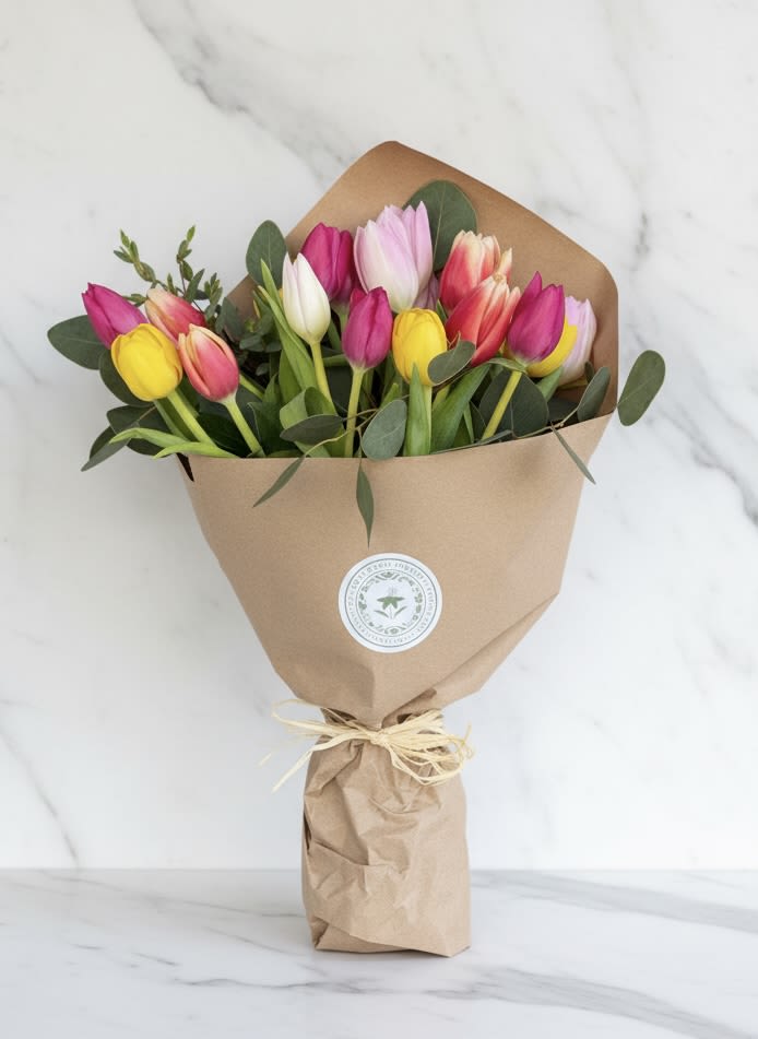 Spring Tulip Wrap - Spring Tulip Wrap for Mother’s Day featuring 20 fresh tulips with seasonal greens and delicate filler, hand-wrapped in our signature style. A simple, abundant bouquet perfect for gifting. Pickup only.  availability.