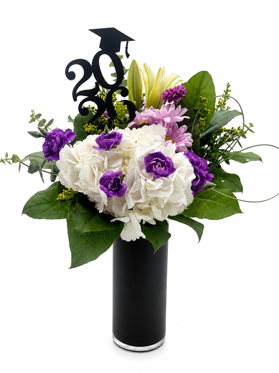 Lavender Honors (V Signature™) - Lavender Honors™ A Graduation Signature Arrangement by Velvet Stems  Celebrate their milestone with flowers as memorable as the moment itself. Lavender Honors™ features an elegant blend of lush white hydrangeas, soft lavender blooms, vibrant purple accents, fresh greenery, and a graduation topper designed to honor their achievement in style. Designed in a sleek black vase, this arrangement brings together sophistication, celebration, and school spirit in one unforgettable presentation.  Perfect for graduation parties, senior photos, ceremonies, or gifting your favorite graduate as they step into their next chapter.   This arrangement is exclusively designed and photographed in-house by Velvet Stems. Minor floral substitutions may occur based on availability while maintaining the same overall style, color palette, and value.