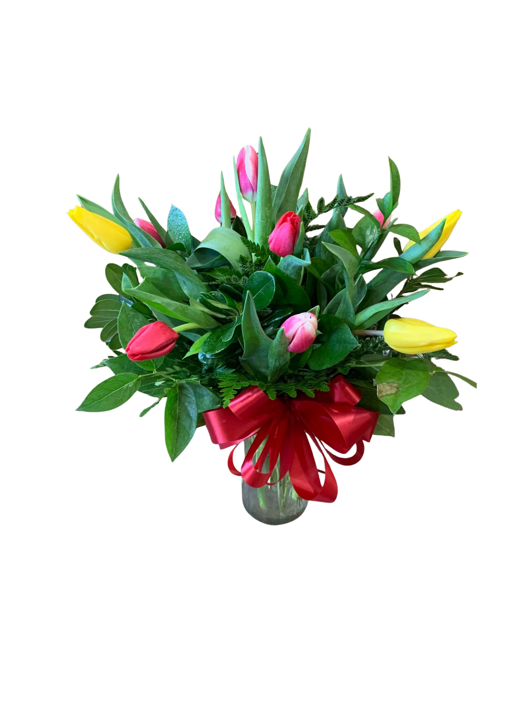 Bouquet of colorful tulips in a glass vase with a red ribbon