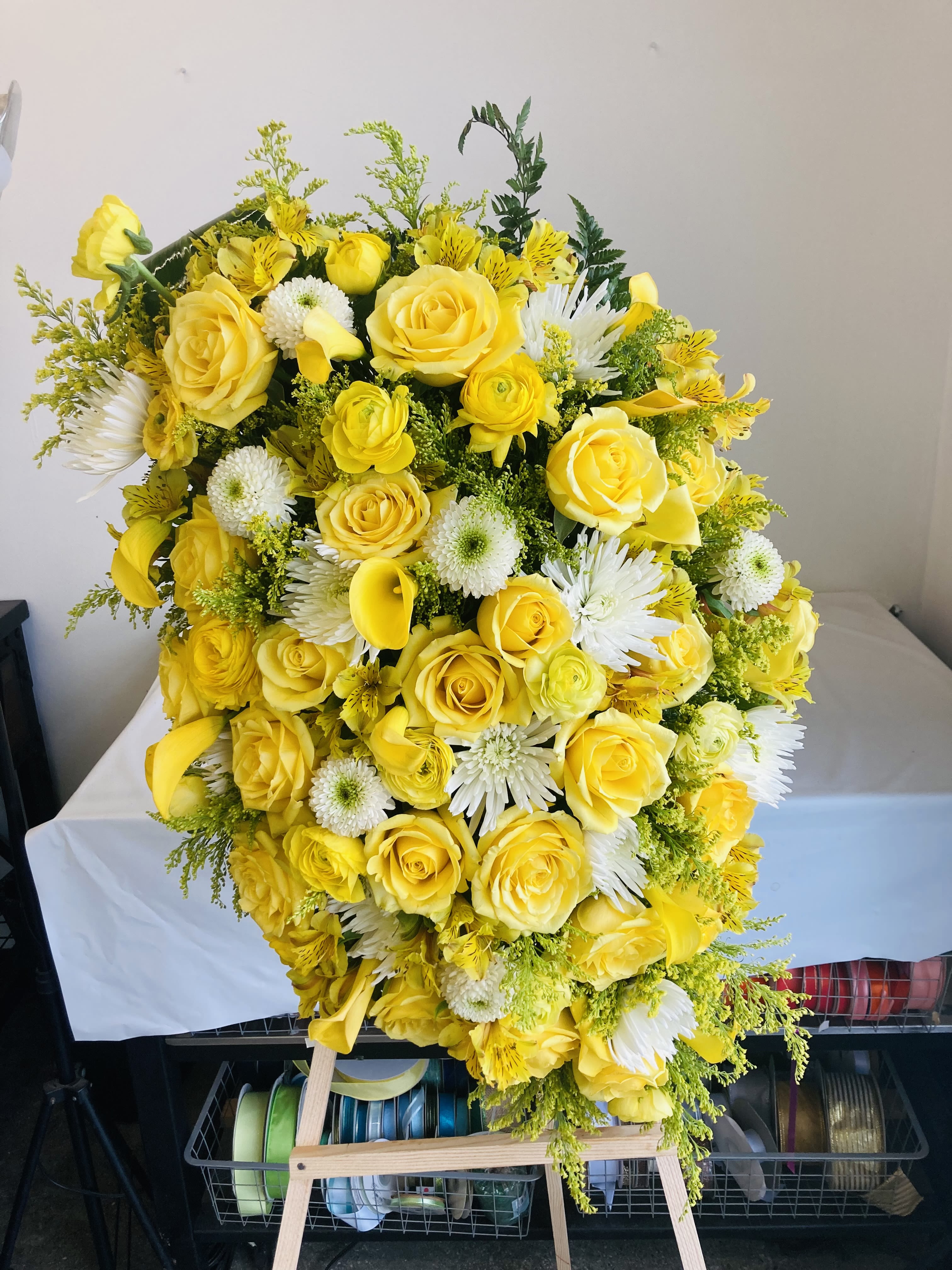 Large yellow and white floral spray with roses and daisies