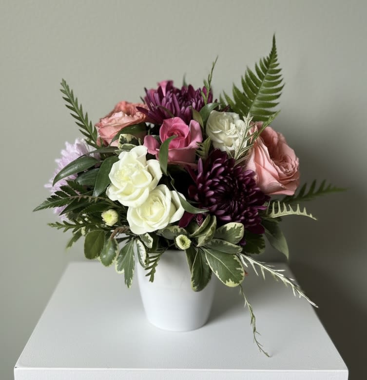 Pitch Perfect - A short and stout vase filled with the perfect blend of white purple pink and peach blooms