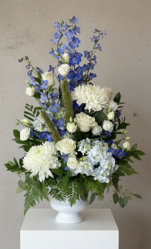 Sincerest Wishes - Blue and white tribute....perfect for a man. Giant chrysanthemums, delphinium, hydrangea, Lisianthus and much more.