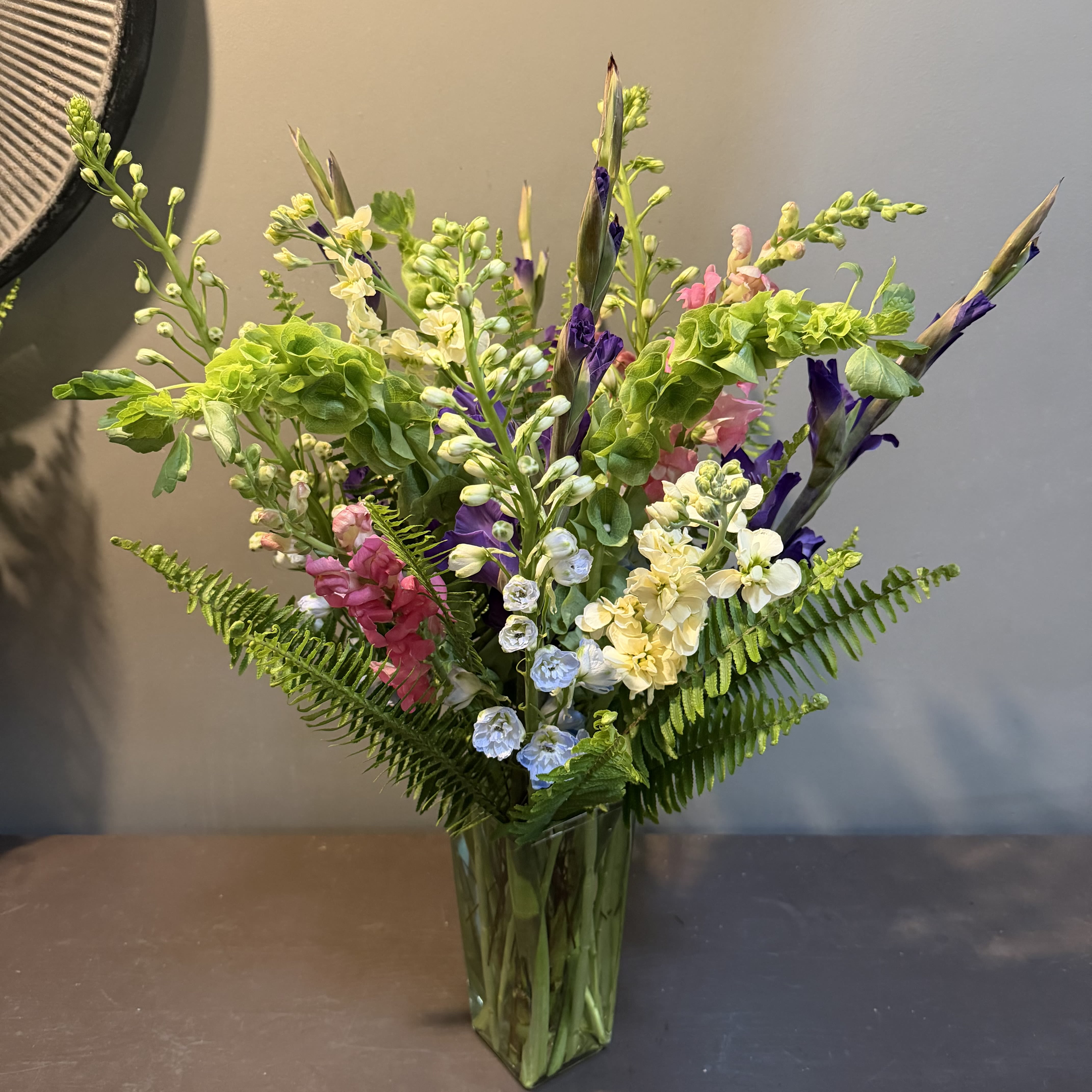 Reach for the Stars - This whimsically, vertical bouquet will bring joy to any room.  Approx. Dimensions: 27"Tx21"W and arrives in a glass vase.
