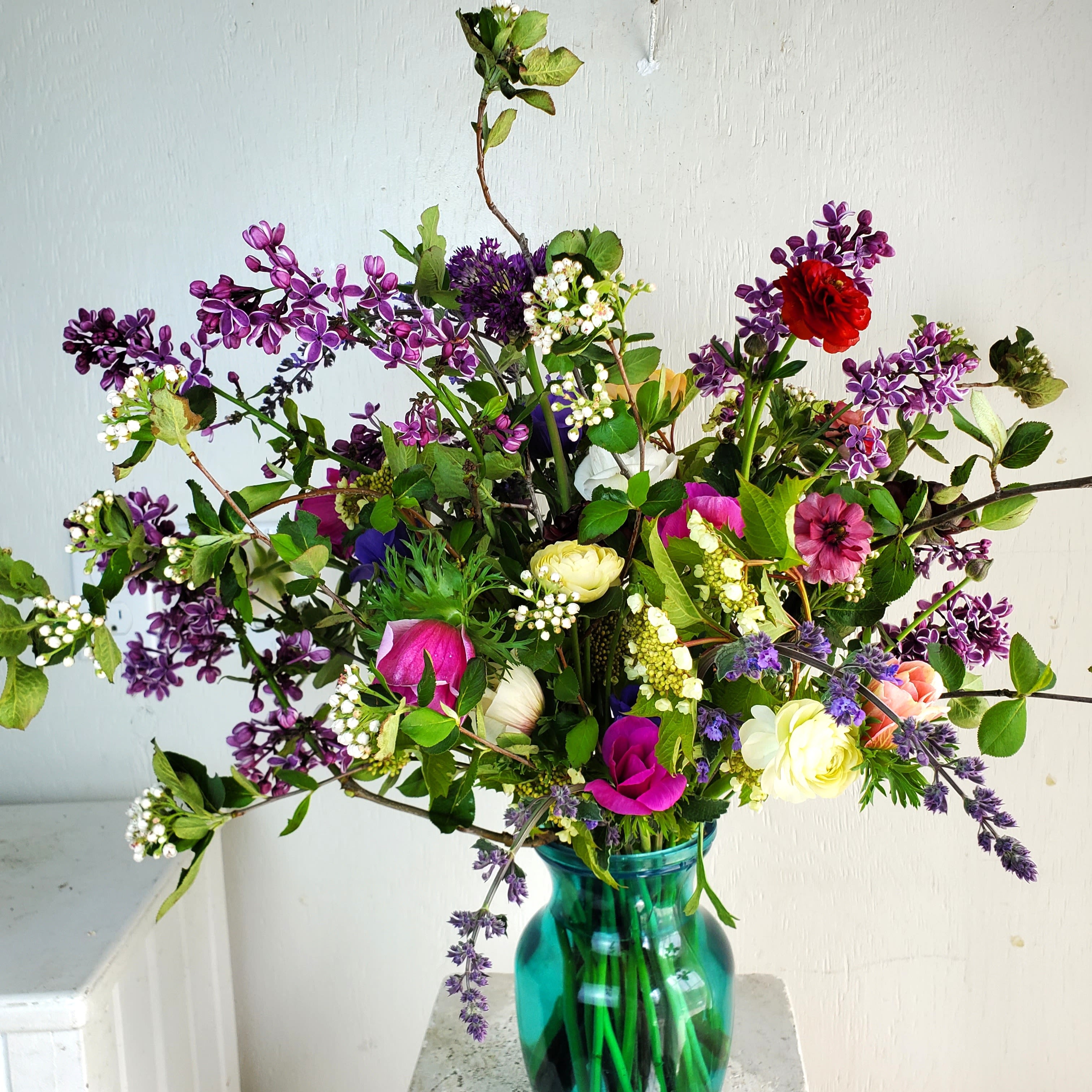 Happiness In a Jar (Growers Choice) - We are a small studio florist in a small town. Every bouquet we create is a one-of-a-kind creation, tailored to the season, availability of flowers, color choice, artistic interpretation, and the current materials available. The photos do not represent the exact flowers that will be delivered. They are intended to provide you with an idea of what we do, how we do it, and the variance that can be expected.The season, availability of flowers, color choice, artistic interpretation, and the current materials available. The photos do not represent the exact flowers that will be delivered. They are intended to provide you with an idea of what we do, how we do it, and the variance that can be expected.  