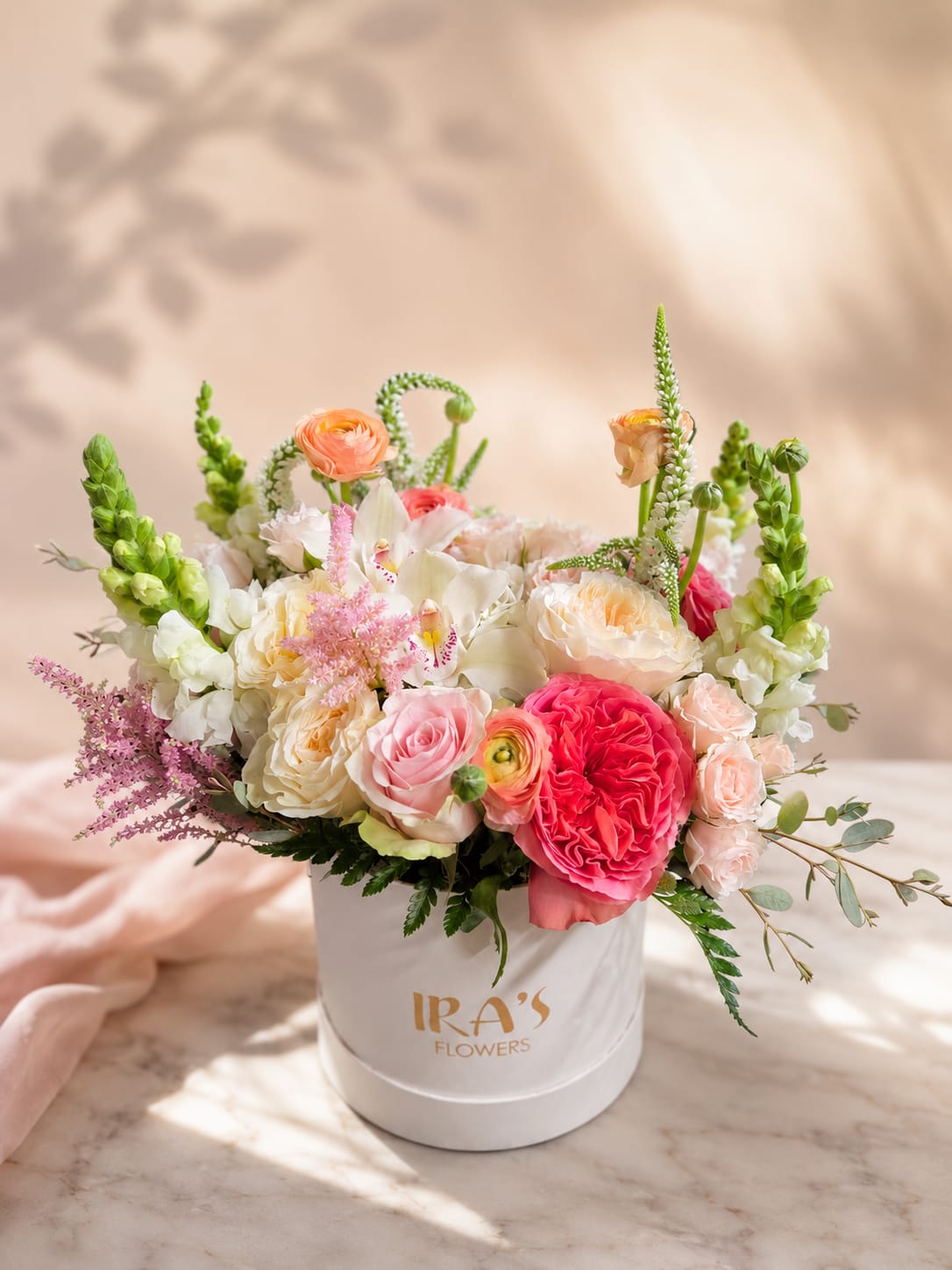Iridescent  - A white hatbox arrangement of white and pink flowers. Delicate just like your loved ones beauty. Give them something unique and stylish. 