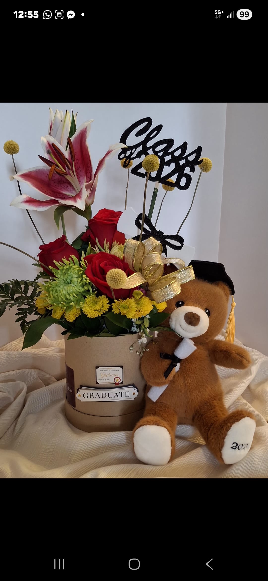 The Valedictorian Bloom - The Valedictorian Bloom captures the energy of success with its bold red roses and bright lime-green accents. Accompanied by a charming graduate teddy bear, this handcrafted permanent arrangement is a trophy of hard work and dedication.