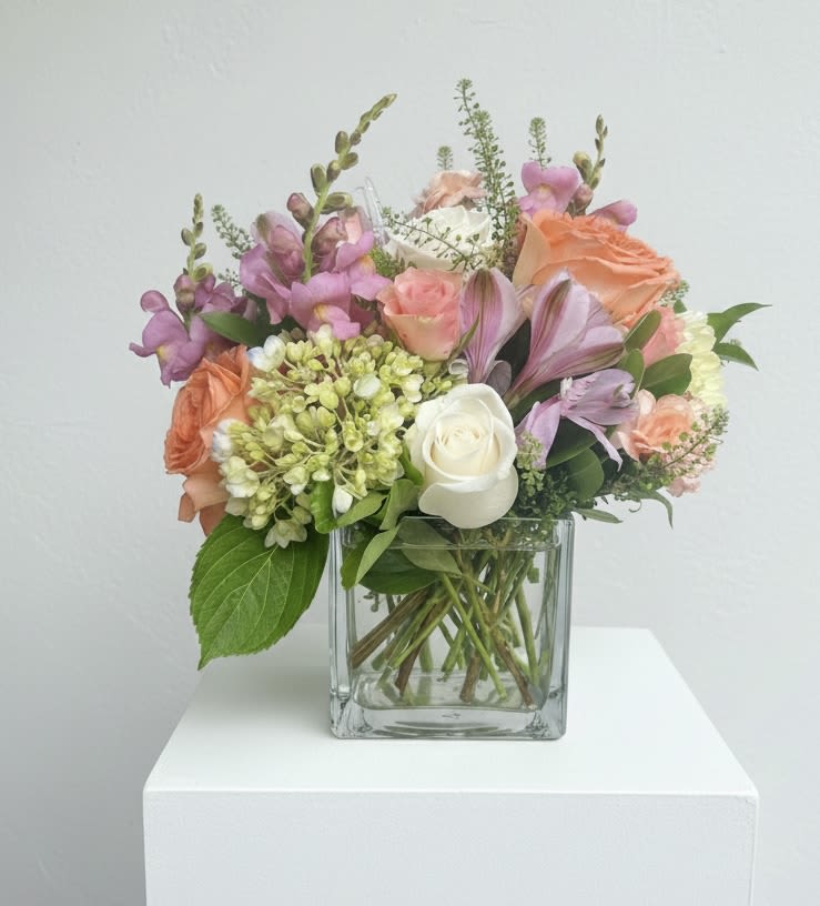 Sherbet Sunsets  - Soft pink and peach-toned blooms mingle with lavender snapdragon spikes in a fresh flower arrangement