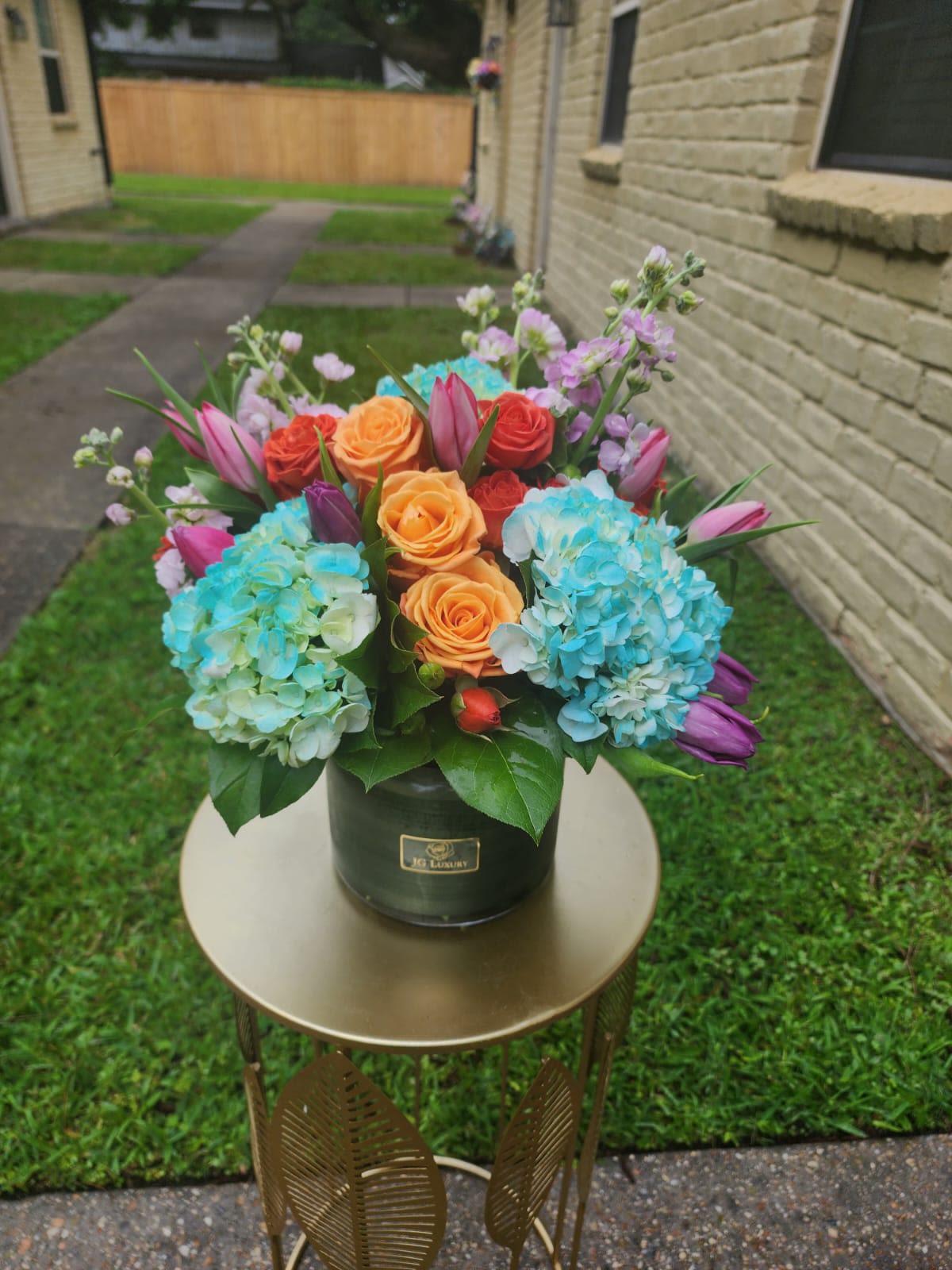 Happy Days - Tulips, roses, hydrangeas, spray roses, all arranged together to create smiles.