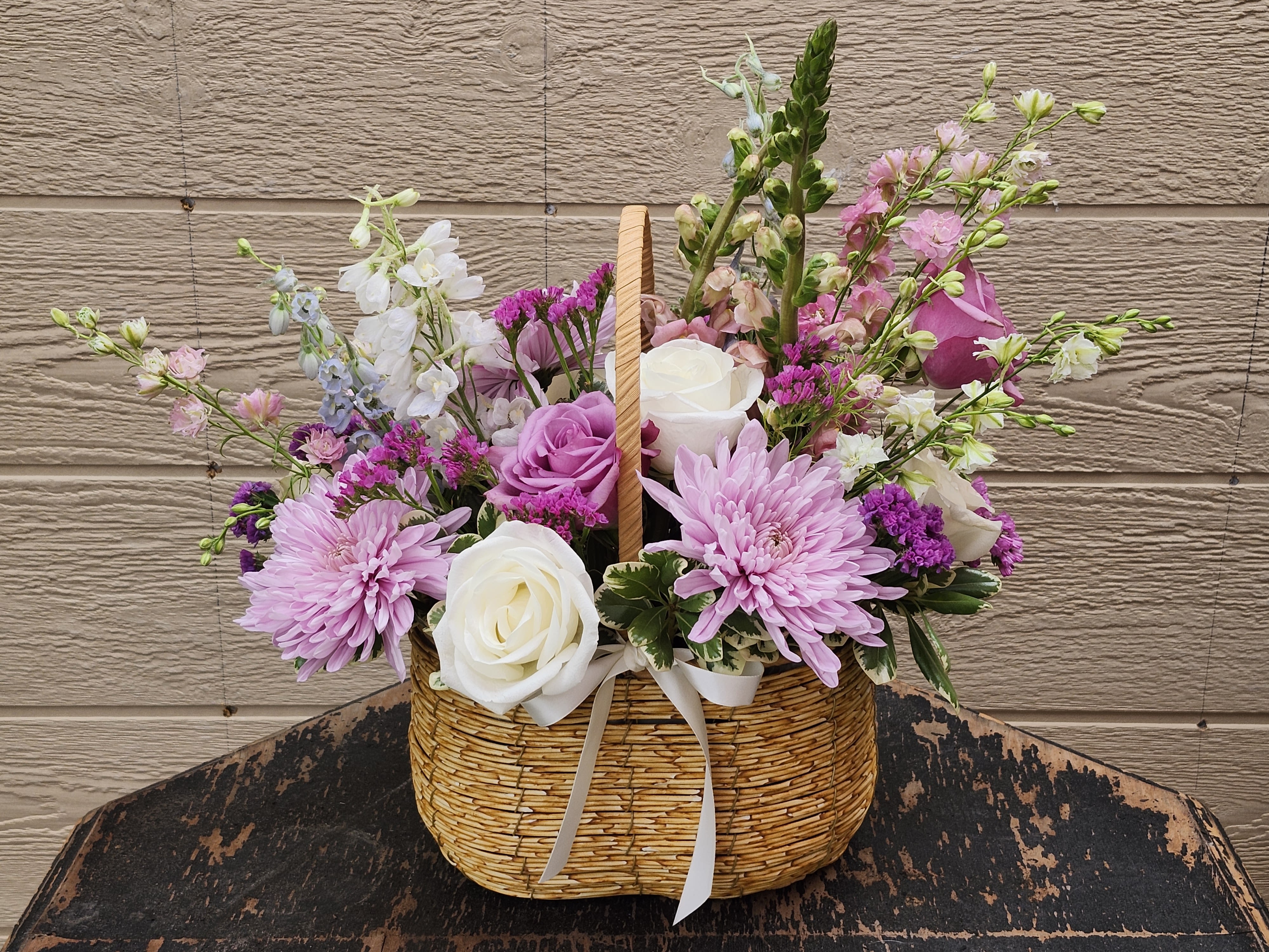 Premium hand basket - Beautiful medium hand basket with premium florals great foe any occasion.  Ready in the cooler for same day delivery or pickup 