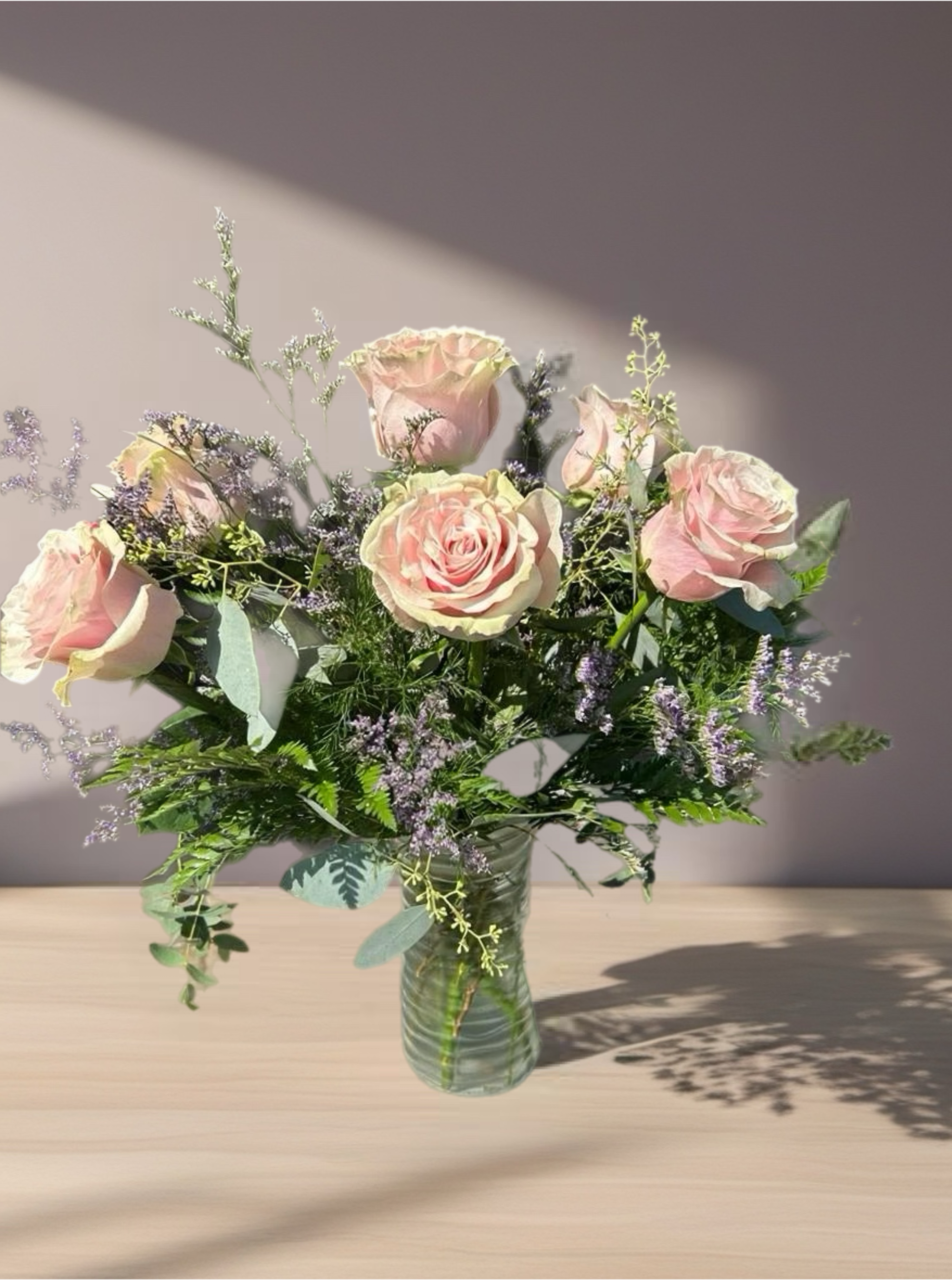 Daydreaming  - Pink roses with a variety of greenery and eucalyptus come together for a lovely arrangement. A stylish and sweet way to dress up any space, send this arrangement for any occasion or just because! APPROXIMATE DIMENSIONS: 15" W x 10" H