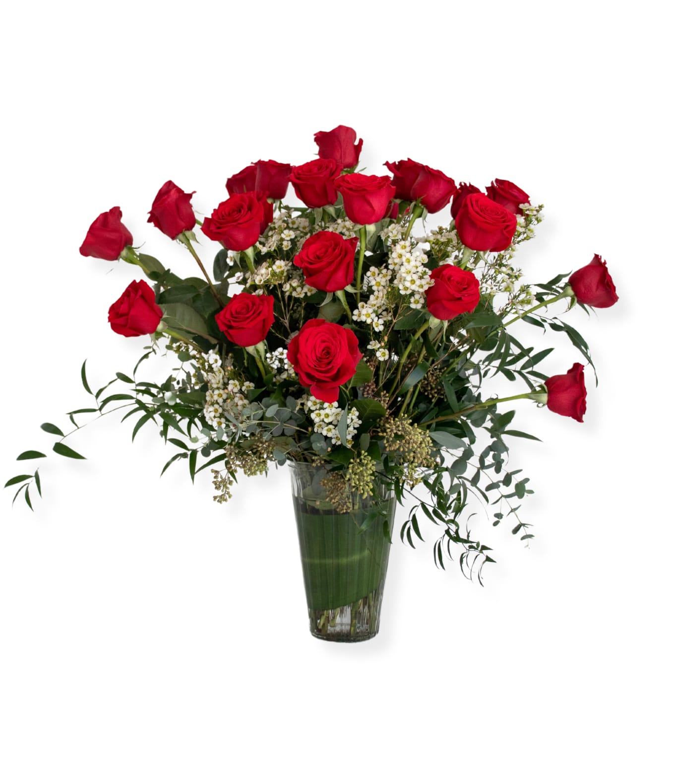 Red roses arranged in a clear glass vase with white filler flowers
