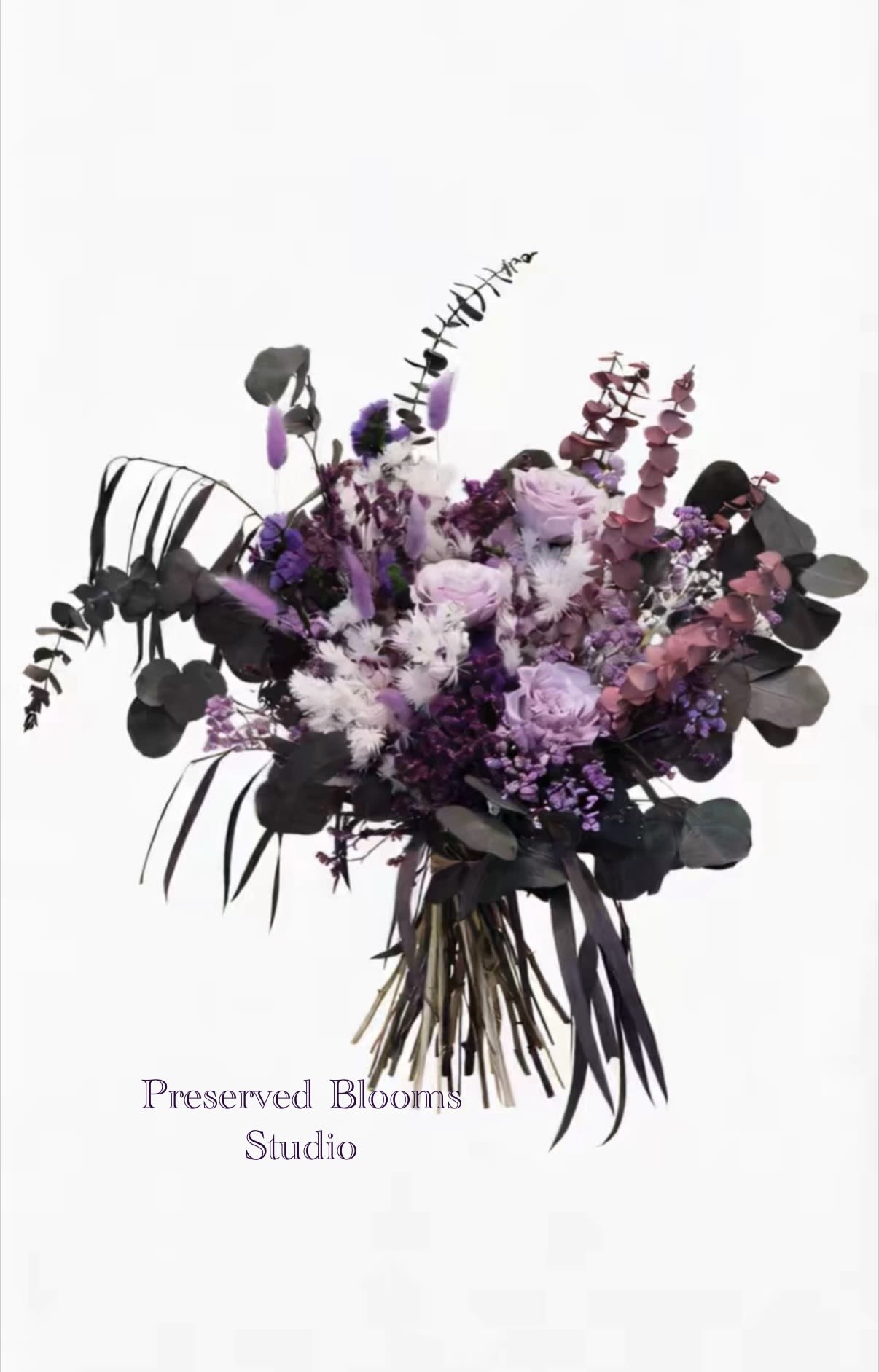Hand-tied bouquet of preserved purple, lavender, and white flowers with dark foliage.