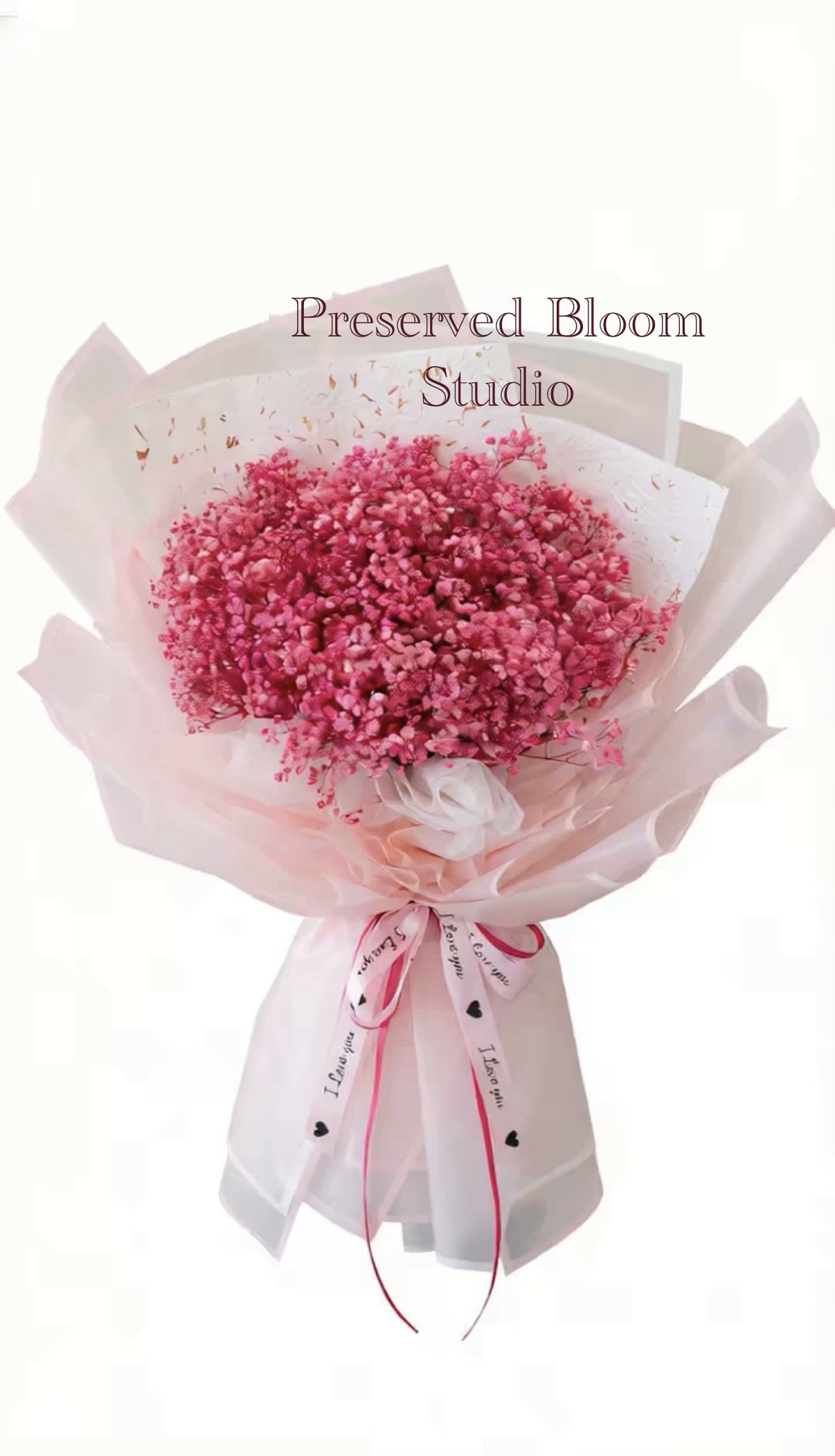Pink preserved flower bouquet wrapped in pale pink paper