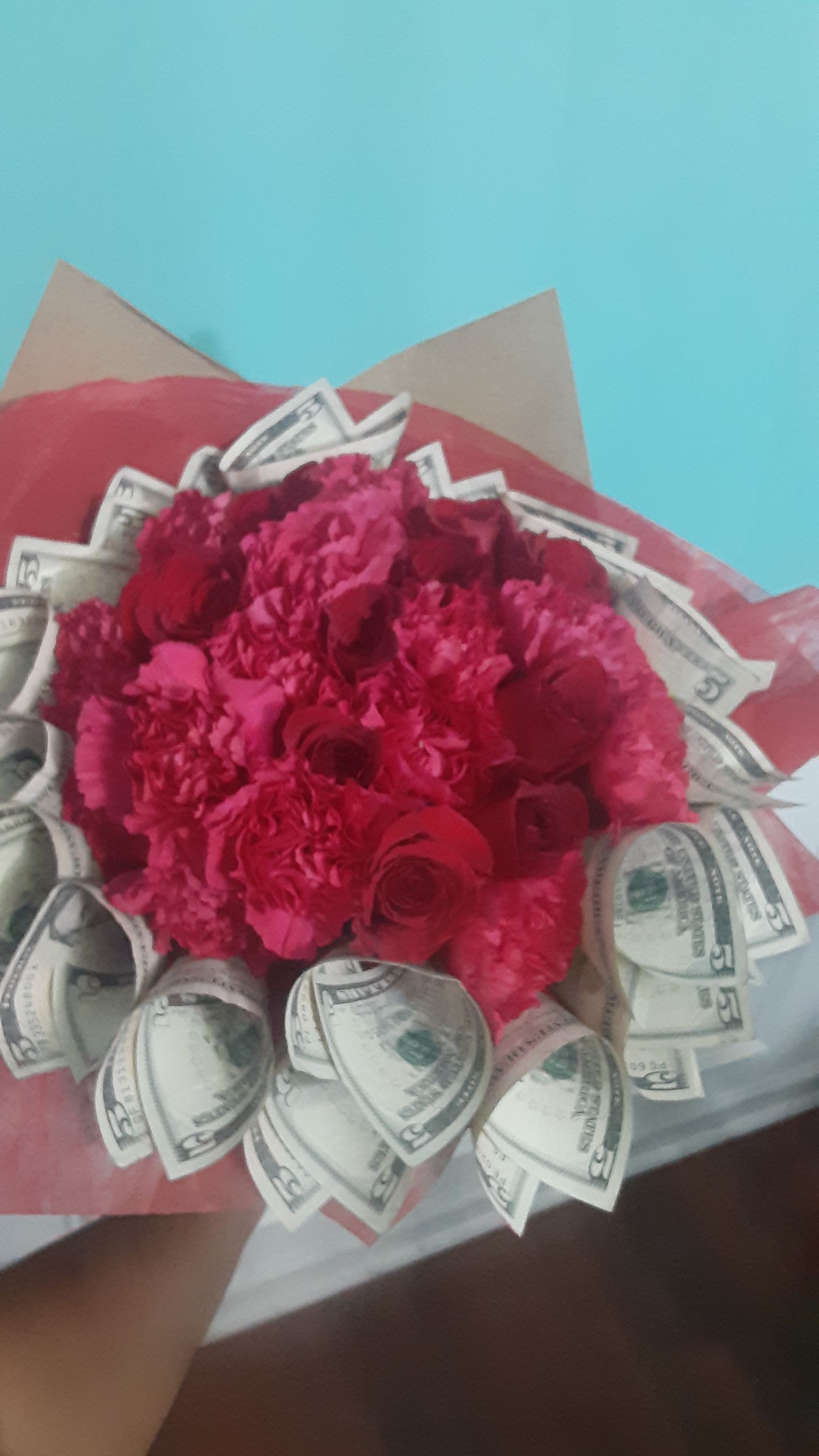Blooms on Cardi - Send these beautiful red roses partnered with rolled dollars (default is total $10 USD in $1s) to your love, your friend, or your relative for Valentine's day. Sending this arrangement is a lovely gesture and shows that you are thinking of them without breaking the bank while still going for broke!  CALL FOR DIFFERENT AMOUNT OR DENOMINATION