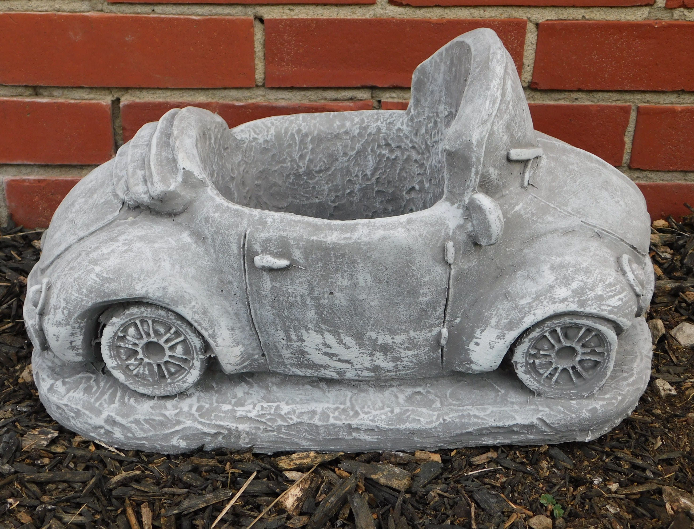 Gray concrete planter shaped like a small car