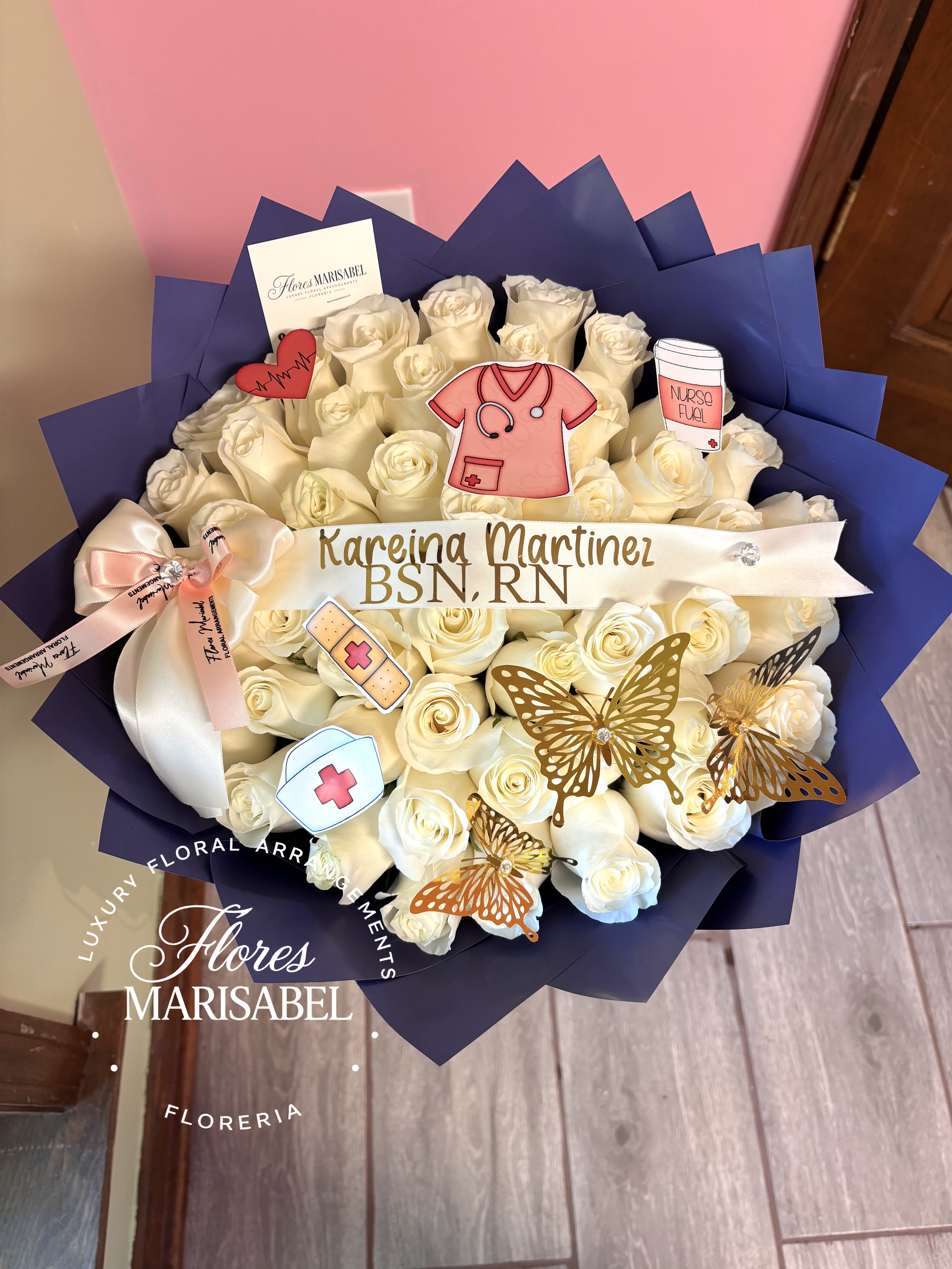 50 rose nurse graduation bouquet  - 50 white rose graduation bouquet. Includes Nurse add ons, 3 butterflies, custom ribbon. Paper color can be chosen. 