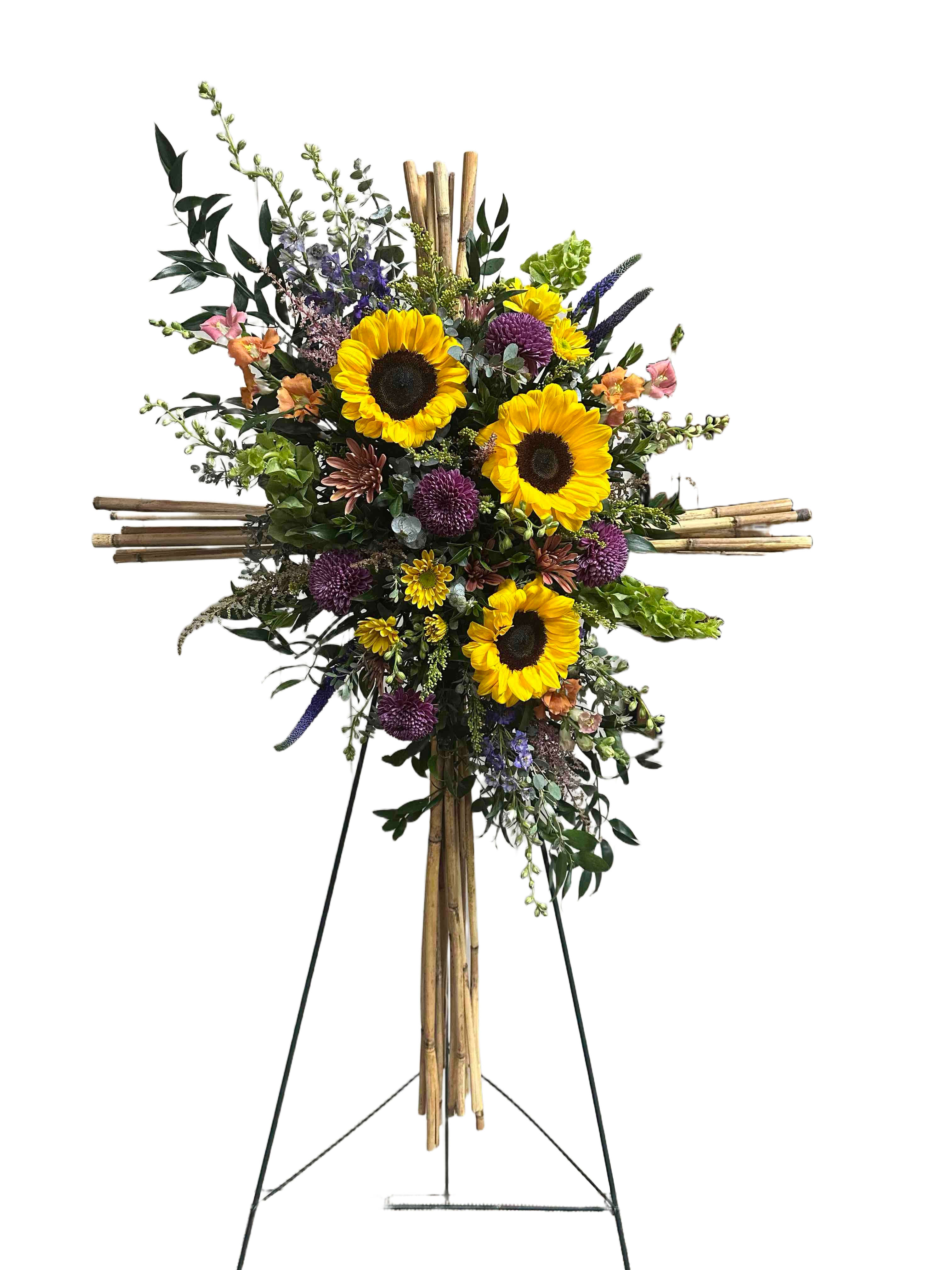 Peaceful Cross  - This peaceful arrangement is comprised of a bamboo cross with sunflowers, chrysanthemums, and snapdragons