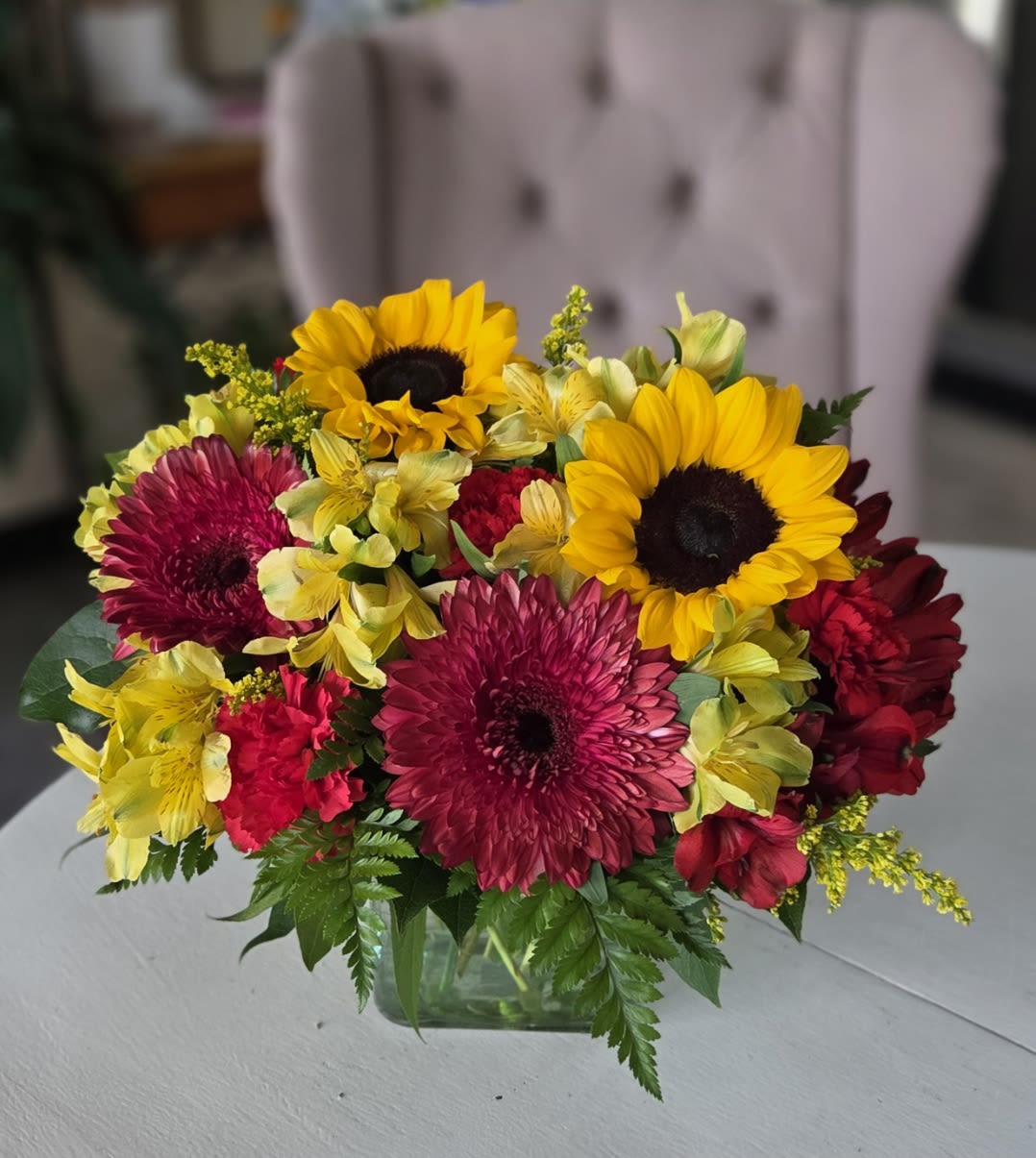 Cinnamon by BloomNation™ - This cinnamon-colored arrangement is a perfect taste of fall. Perfect for any occasion in the fall season, it features red gerbera daisies and yellow alstroemeria.  Approximate Dimensions: 10"D x 10"H