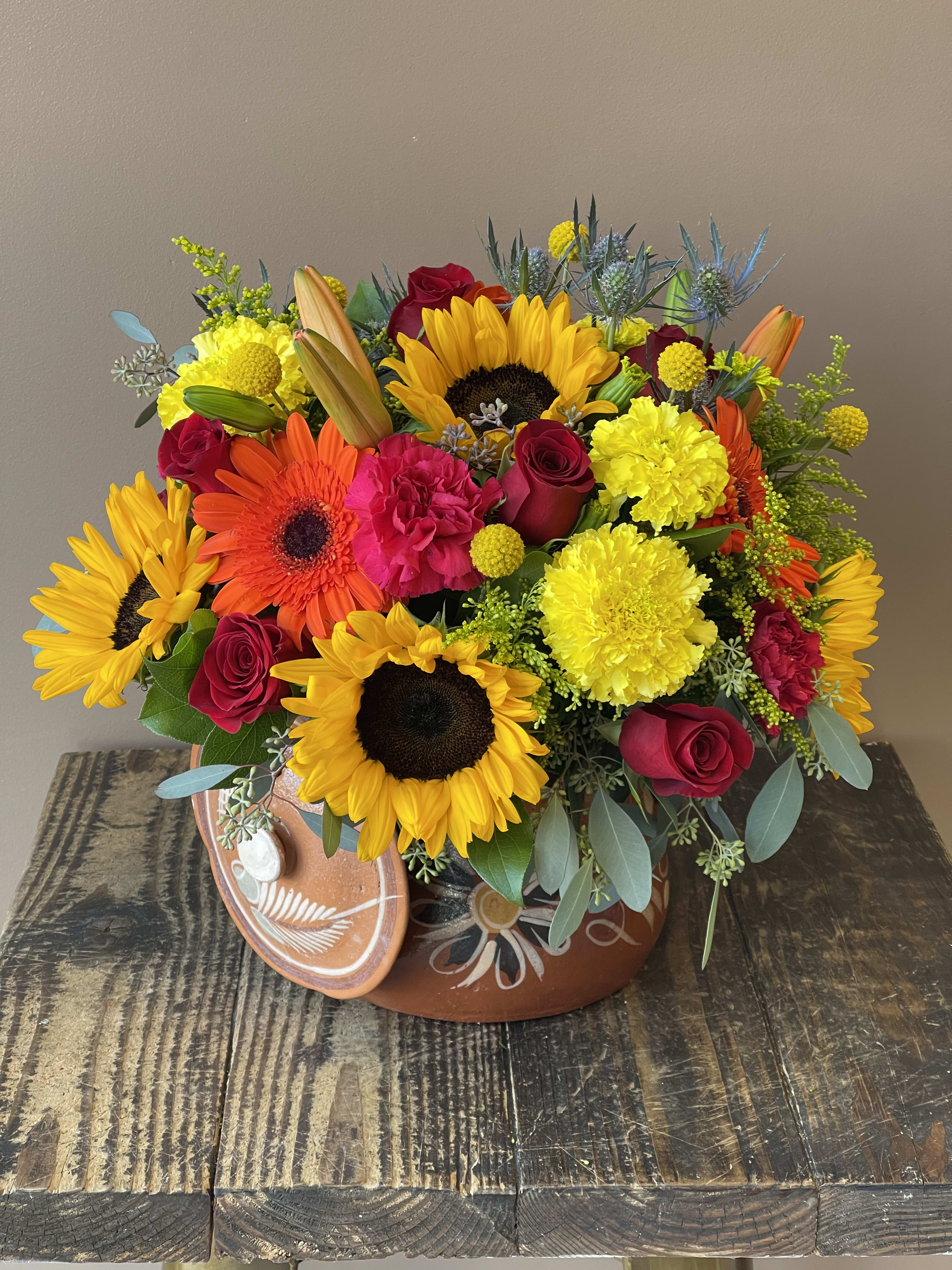 Flores del Campo  - Vibrant colorful arrangement includes a variety of flowers. The vase (pot) is completely reusable for cooking. Dimension is 16”x16” 